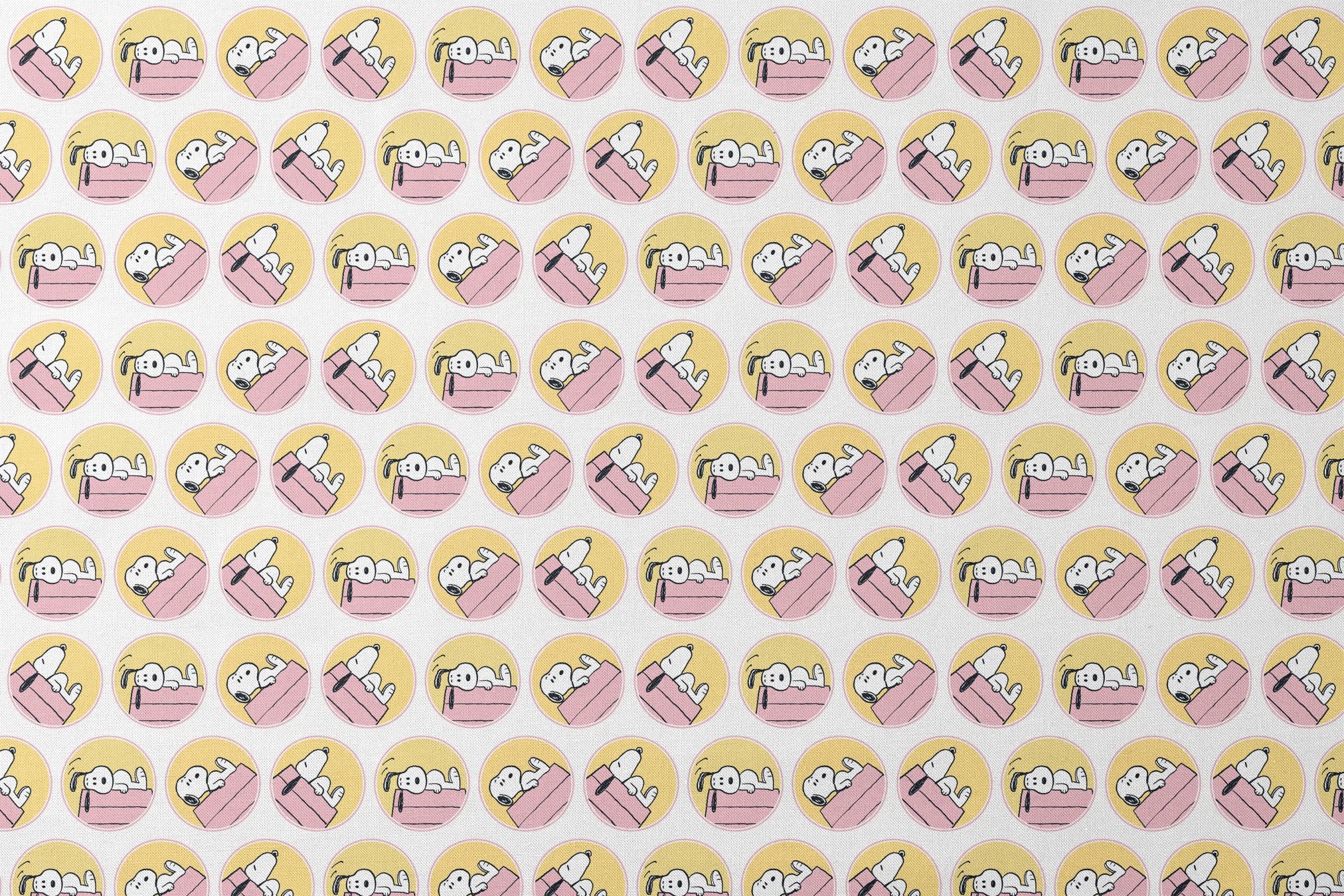 Snoopy lounging on pink doghouse roof in various poses, arranged in circular yellow frames designs flat mockup
