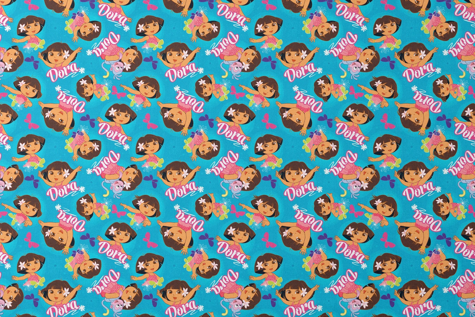 Bright blue pattern with cartoon character Dora, flowers, and "Dora" text repeated throughout designs flat mockup