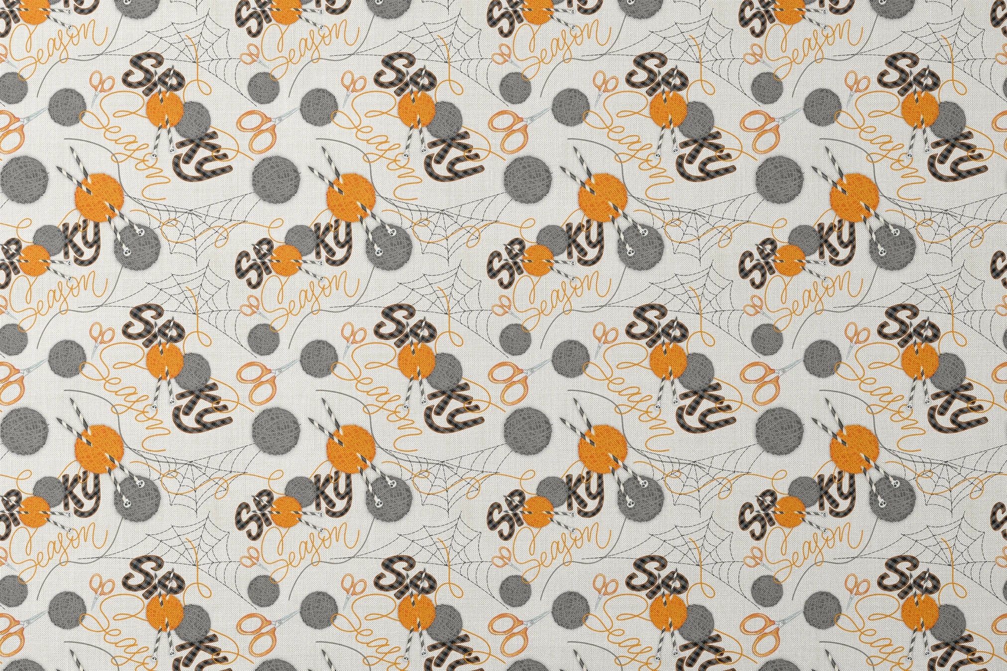Halloween design by Nicole Tamarin featuring orange and gray yarn balls, scissors, spiderwebs, and “Spooky Season” lettering on a cream background. designs flat mockup
