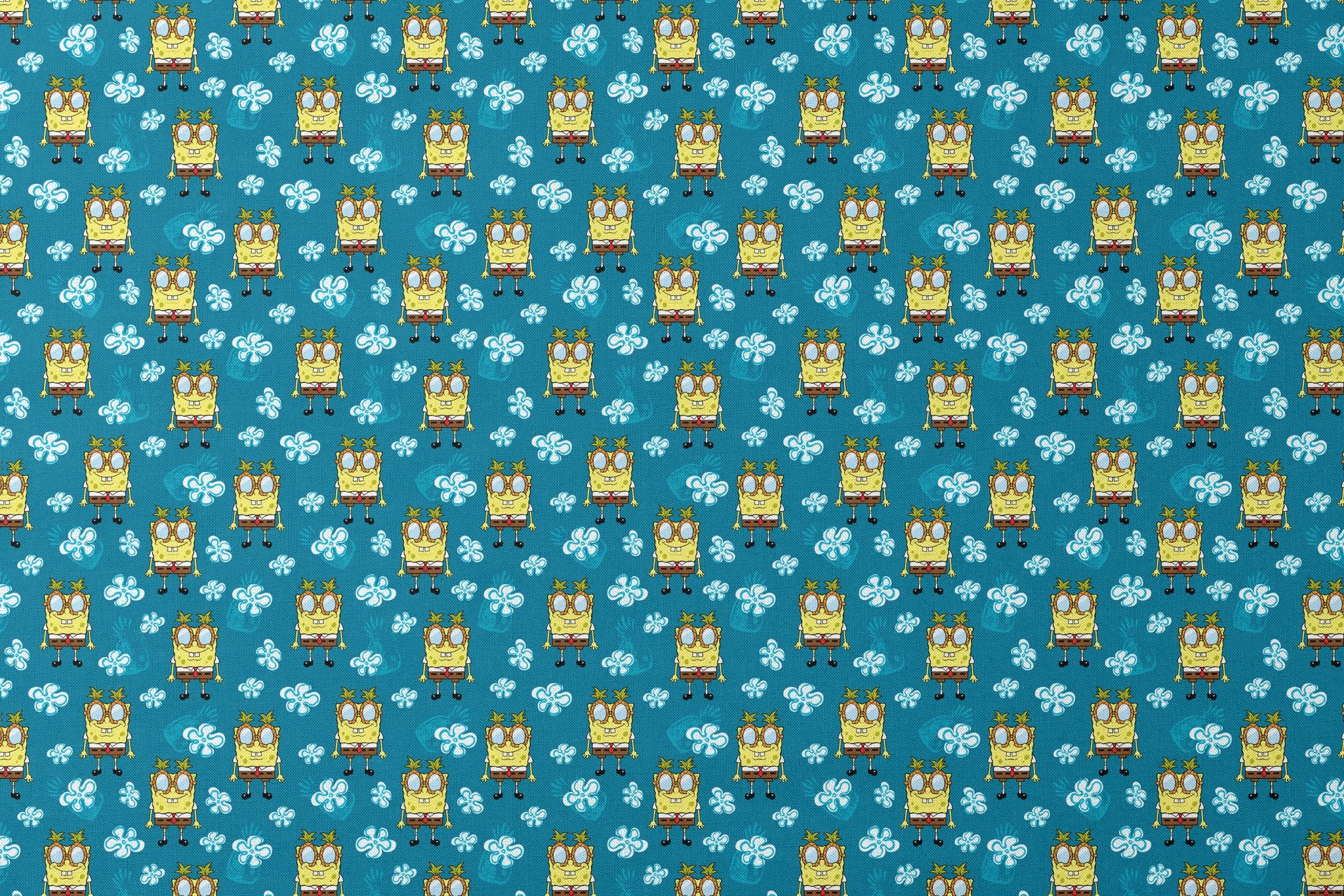 Yellow cartoon character with glasses on teal background with white flower pattern, repeating design designs flat mockup
