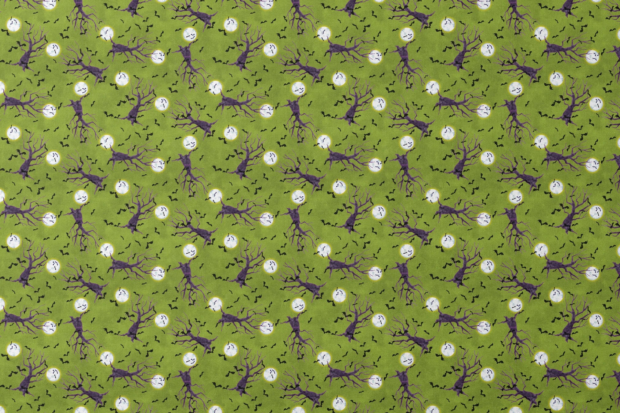 Halloween fabric design with purple haunted trees, bats, and glowing moons on a green background, illustrated by Nicole Tamarin. designs flat mockup