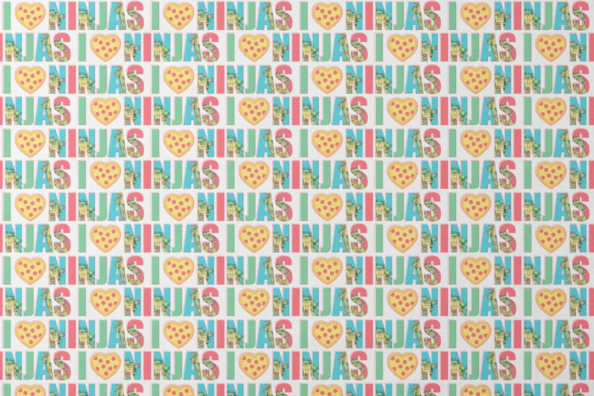 Teenage Mutant Ninja Turtles design with “I heart Ninjas” text with a pizza heart graphic, and Michelangelo and Leonardo in pastel colors. designs flat mockup