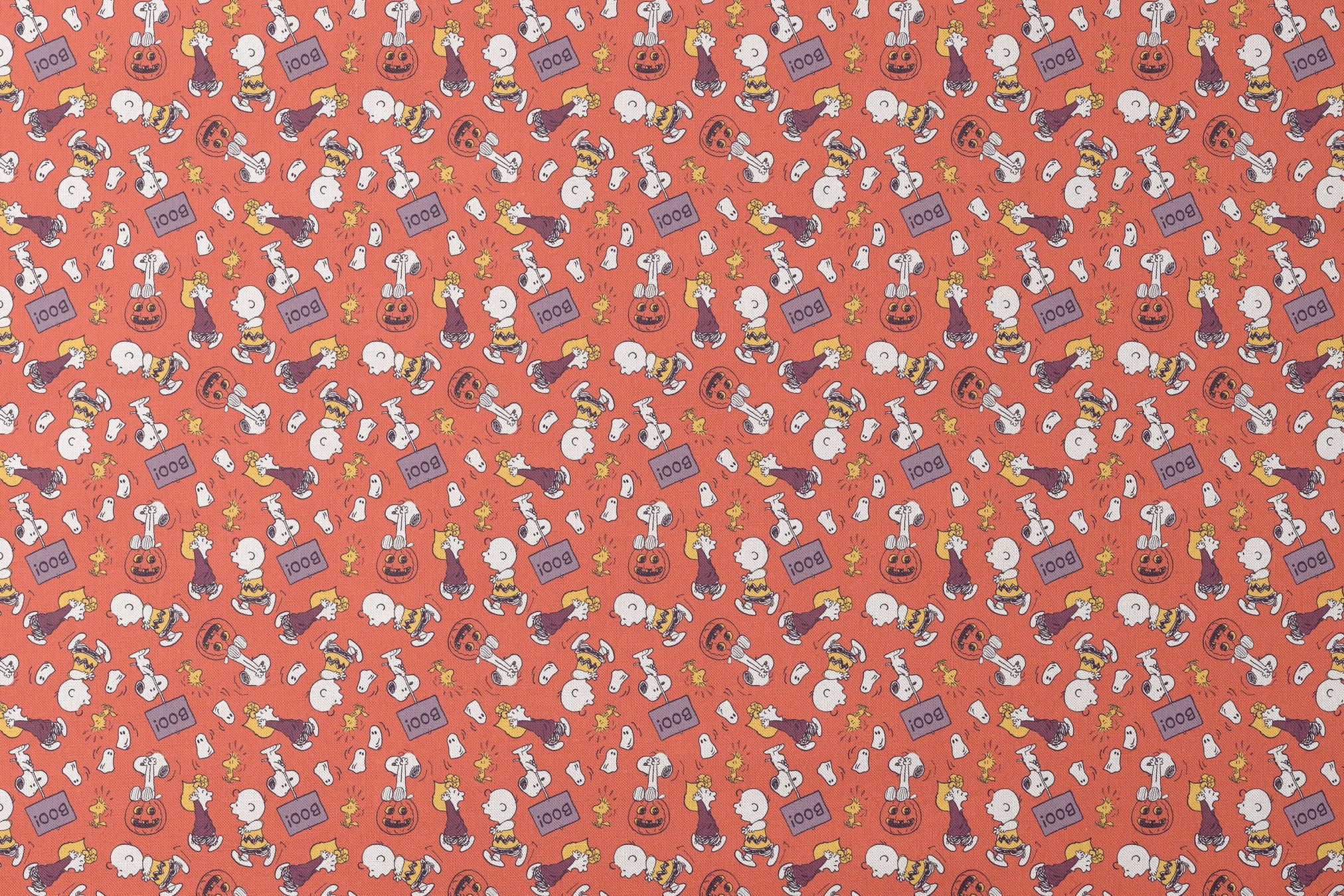 Snoopy and Woodstock Halloween pattern on orange background with pumpkins, ghosts, and "boo" text designs flat mockup