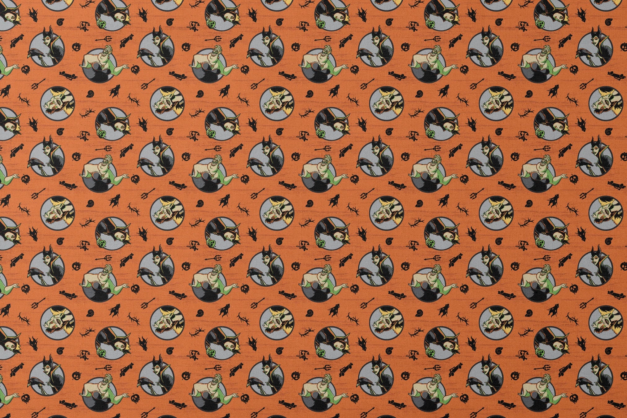Halloween-themed orange pattern with circular Disney Villain portraits, black cats, bats, pumpkins, and spooky symbols designs flat mockup