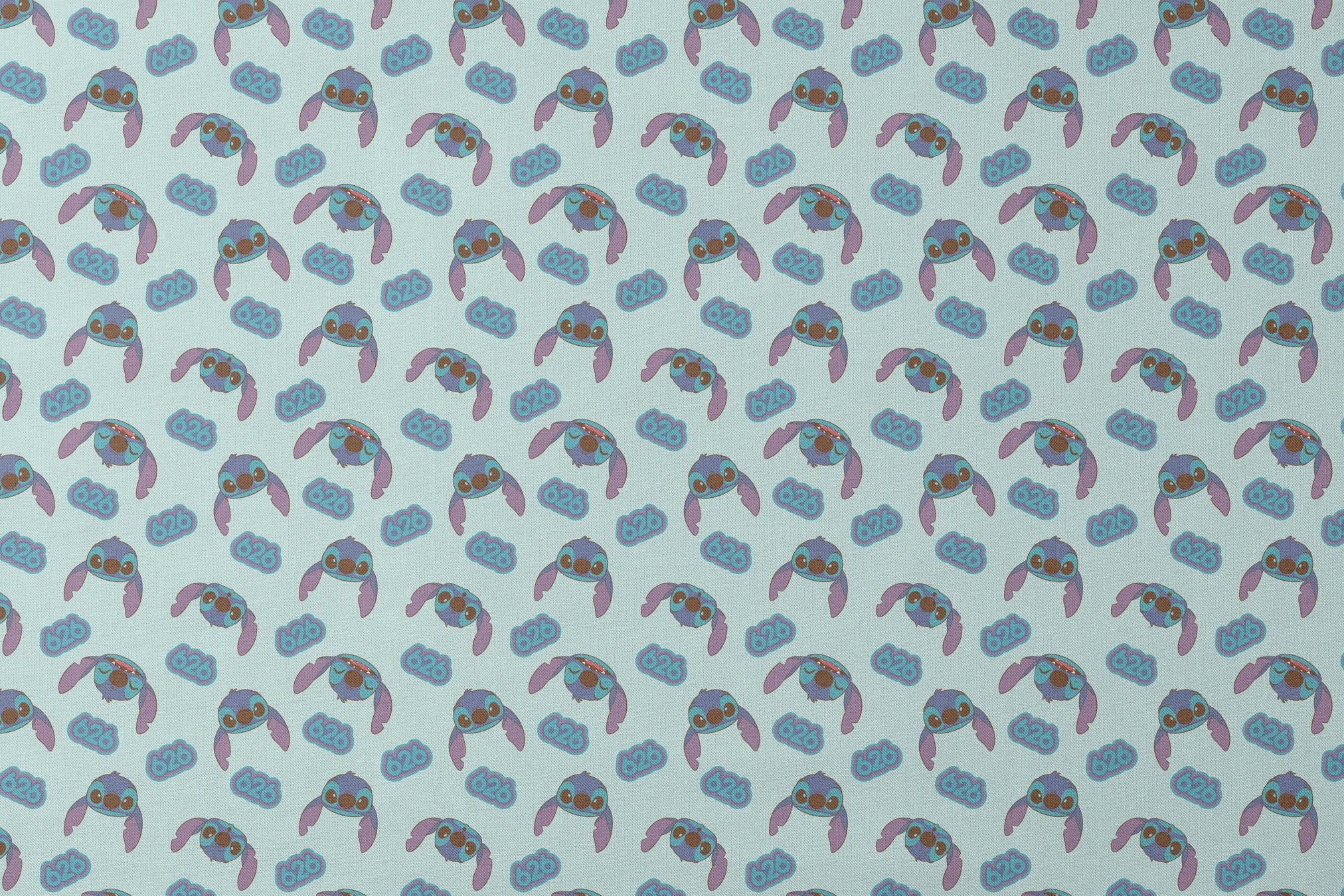 Blue cartoon creatures with large ears and swirl patterns on light teal background designs flat mockup
