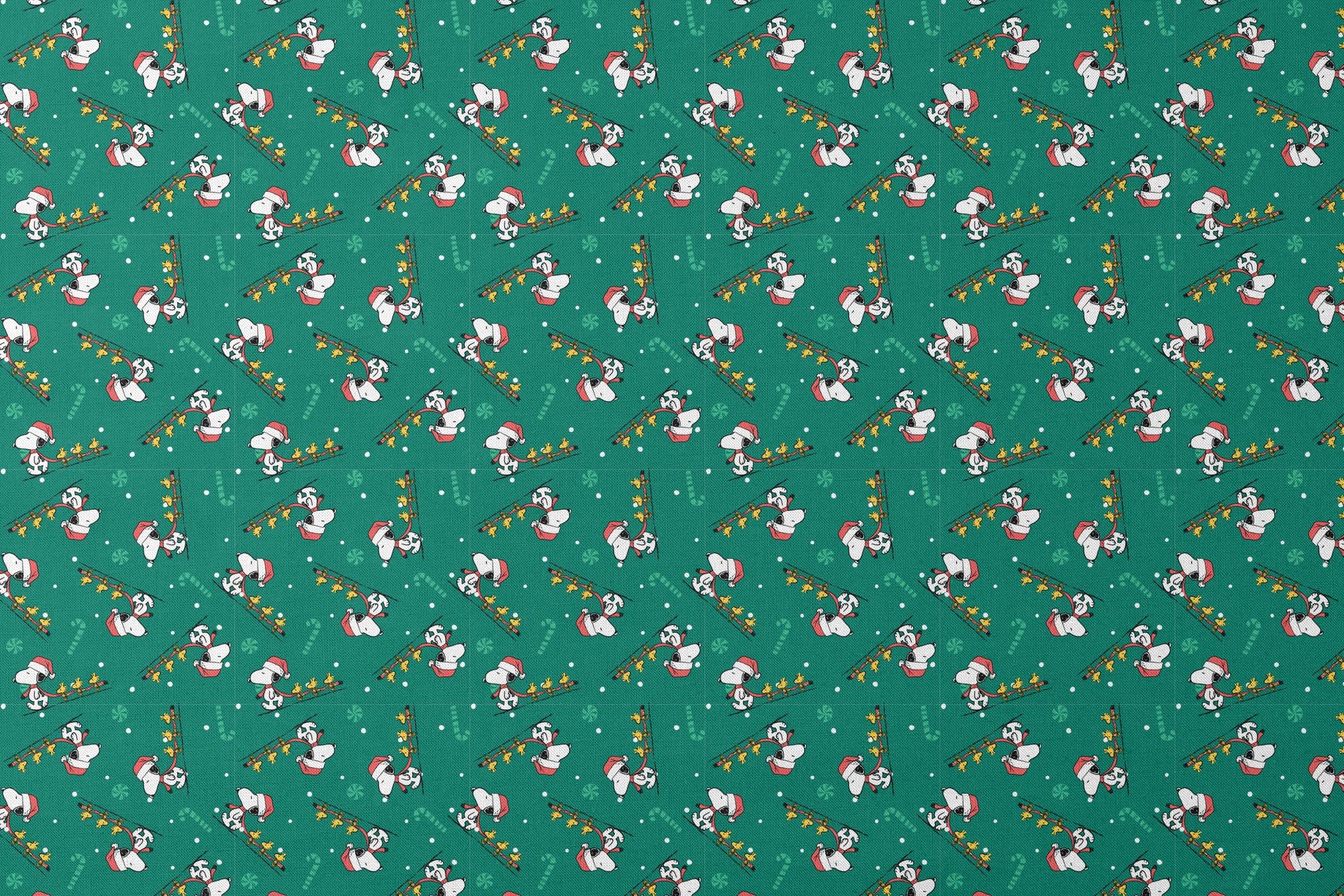 Holiday pattern with Snoopy in Santa hats pulling sleds of stars on green background with candy canes and snowflakes designs flat mockup