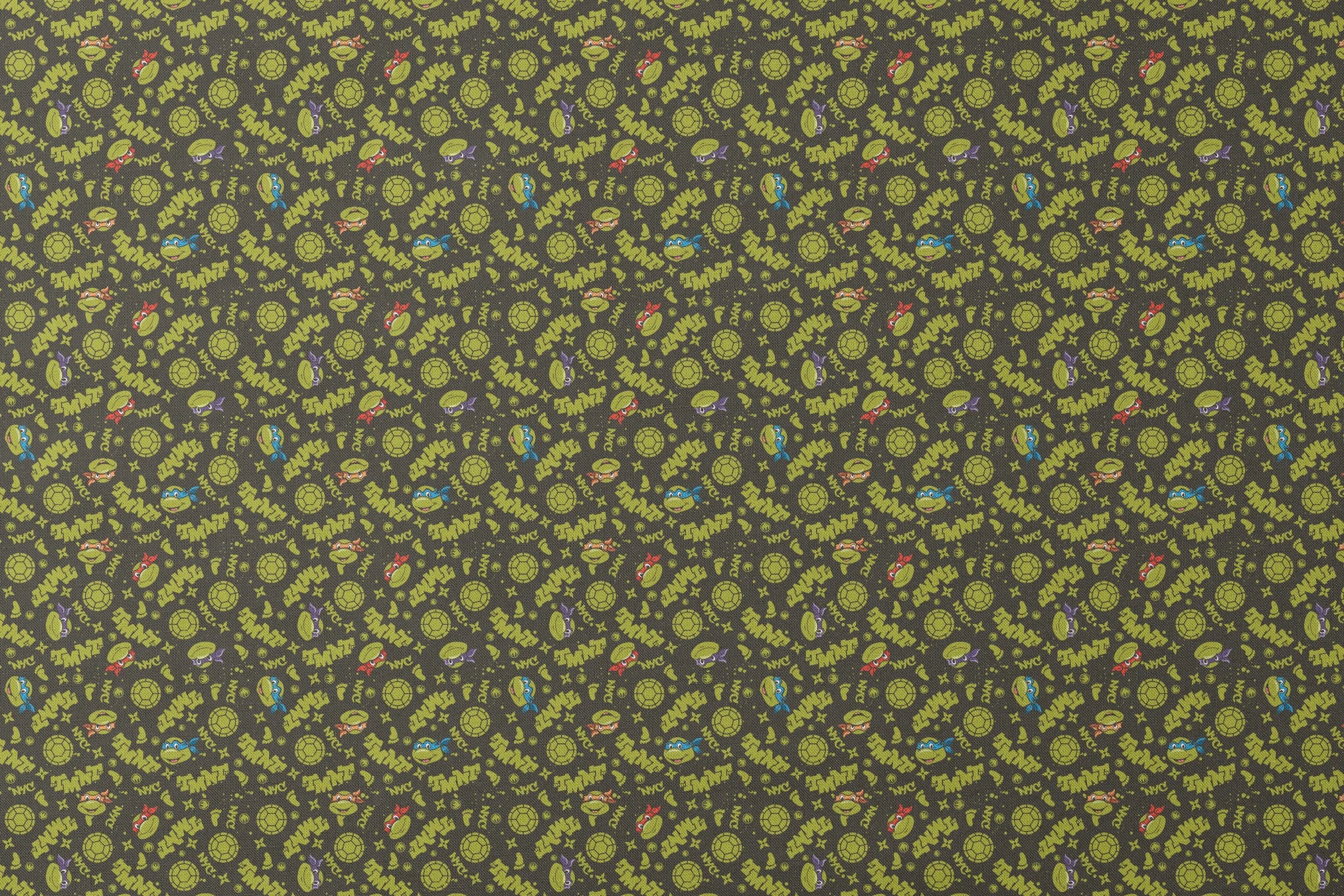 Pattern of Teenage Mutant Ninja Turtles with "TMNT" text on dark background designs flat mockup