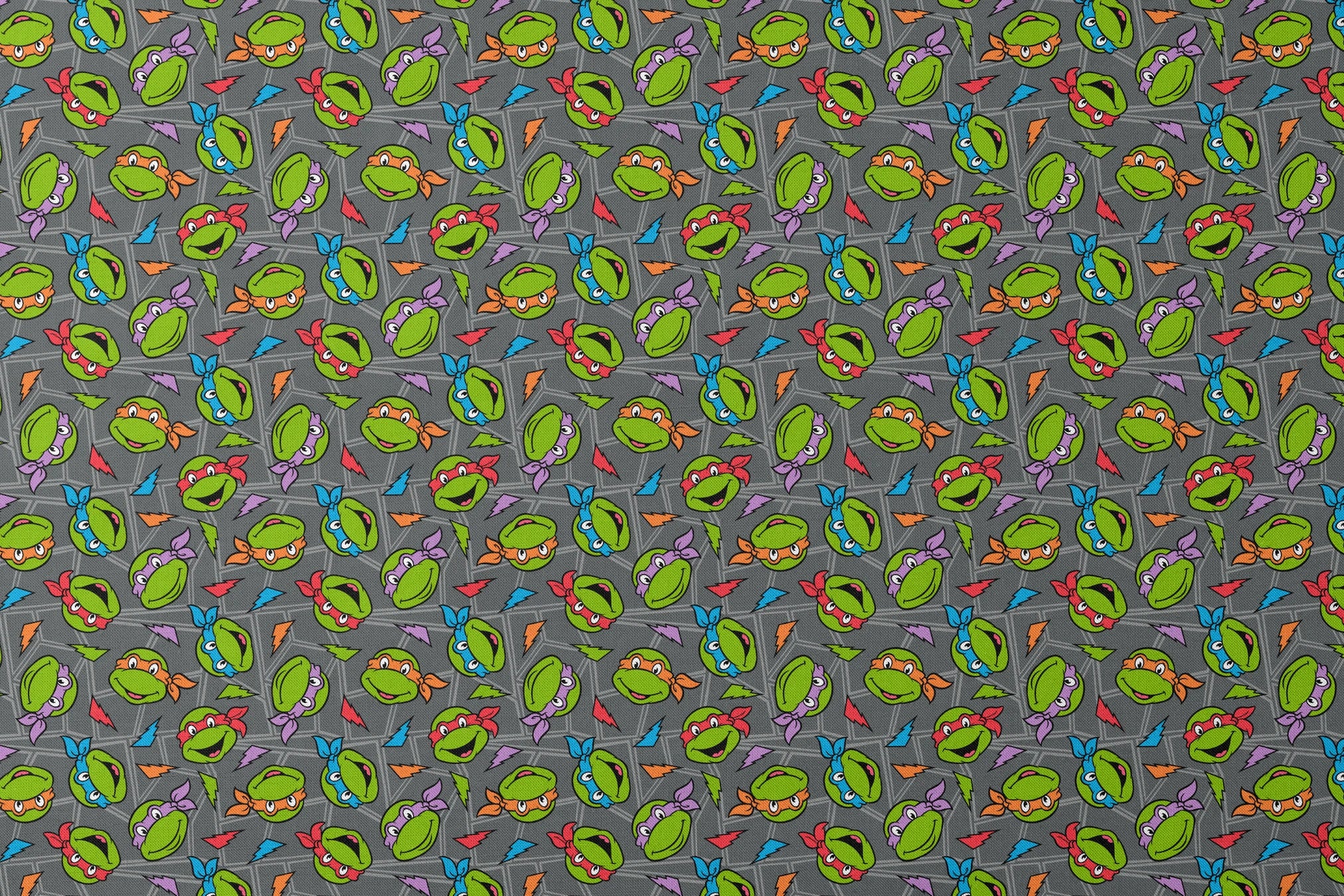 Colorful pattern of Teenage Mutant Ninja Turtles faces with red, orange, blue, and purple masks on grey background. designs flat mockup