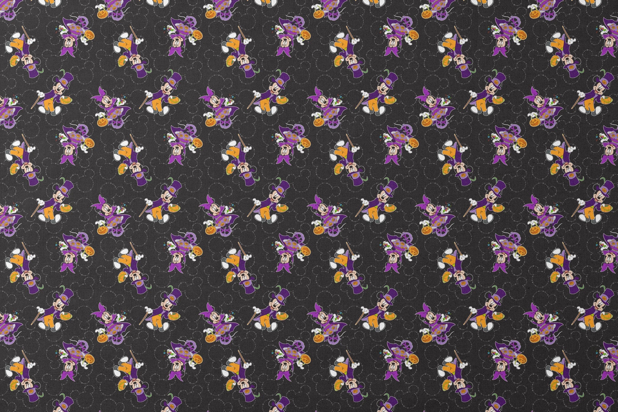 Mickey and Minnie in Halloween costumes on black background with purple, orange, and white details in a scattered pattern designs flat mockup