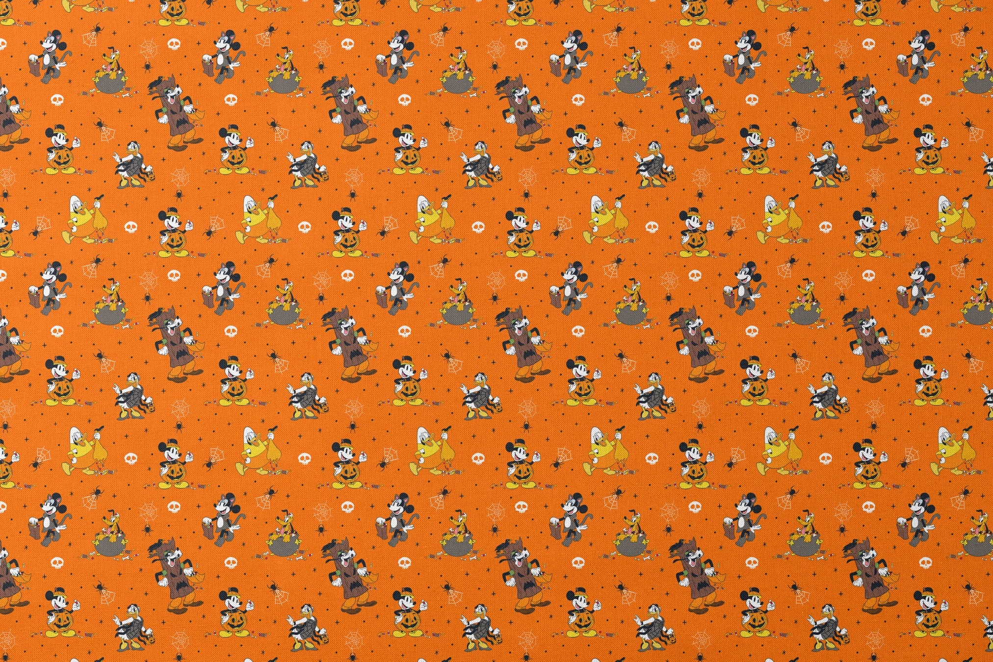 Halloween-themed orange pattern with Disney characters in costumes, spiderwebs, and skulls designs flat mockup