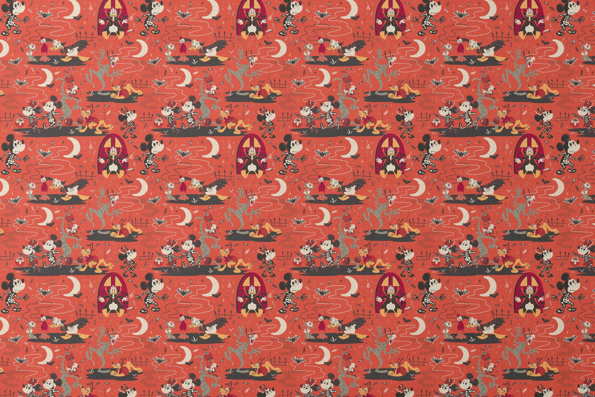 Halloween-themed Disney pattern with Mickey, Minnie, Donald in skeleton costumes on orange background with bats and moons designs flat mockup