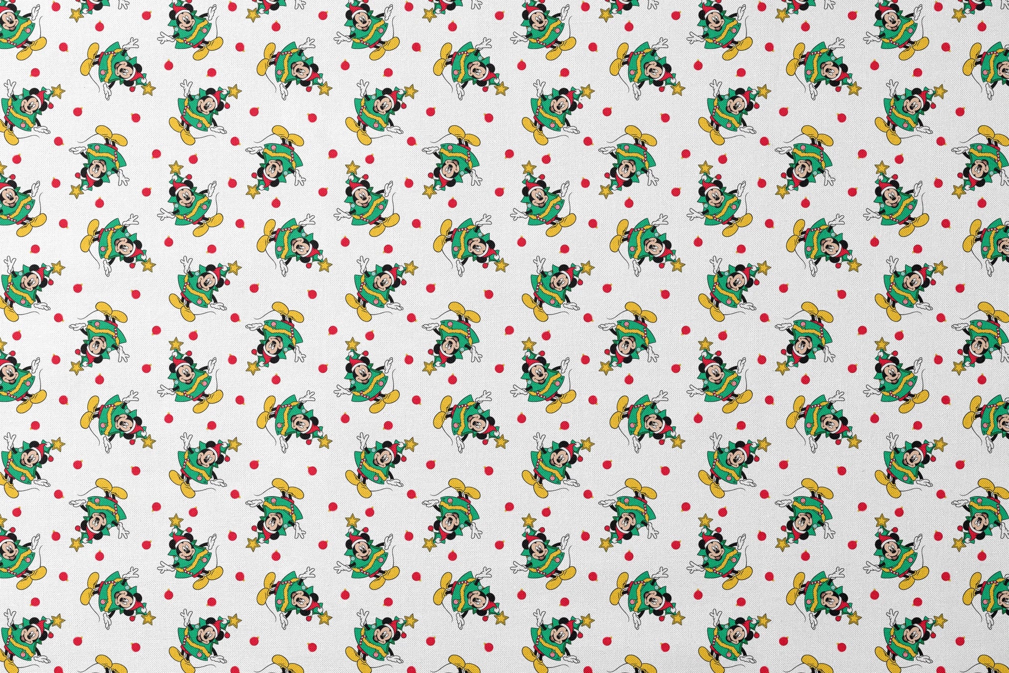 Mickey Mouse in a Christmas tree costume and stars on white background with red dots designs flat mockup