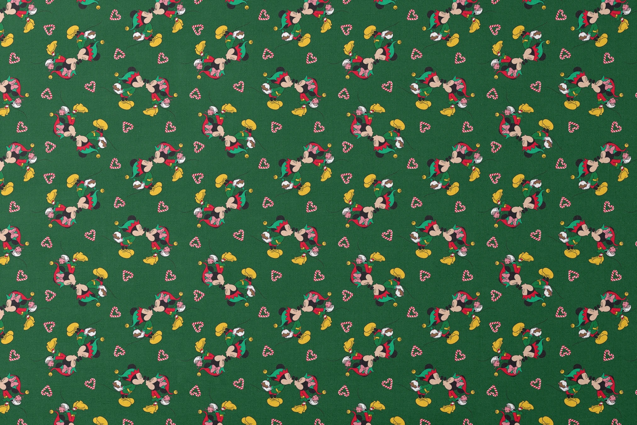 Festive Mickey Mouse pattern with candy canes on green background designs flat mockup