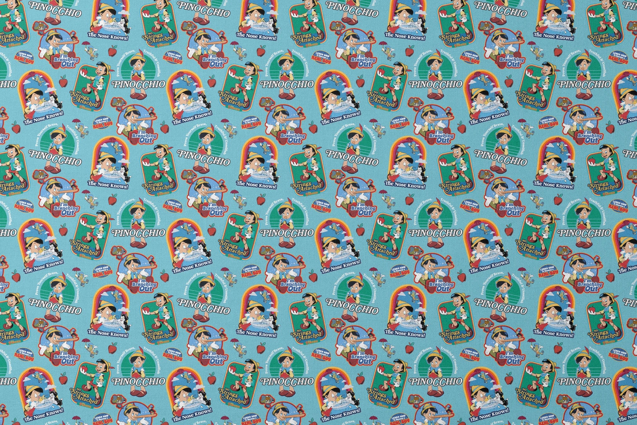 Colorful Pinocchio cartoon pattern featuring puppet characters, slogans, and red apples on teal background designs flat mockup