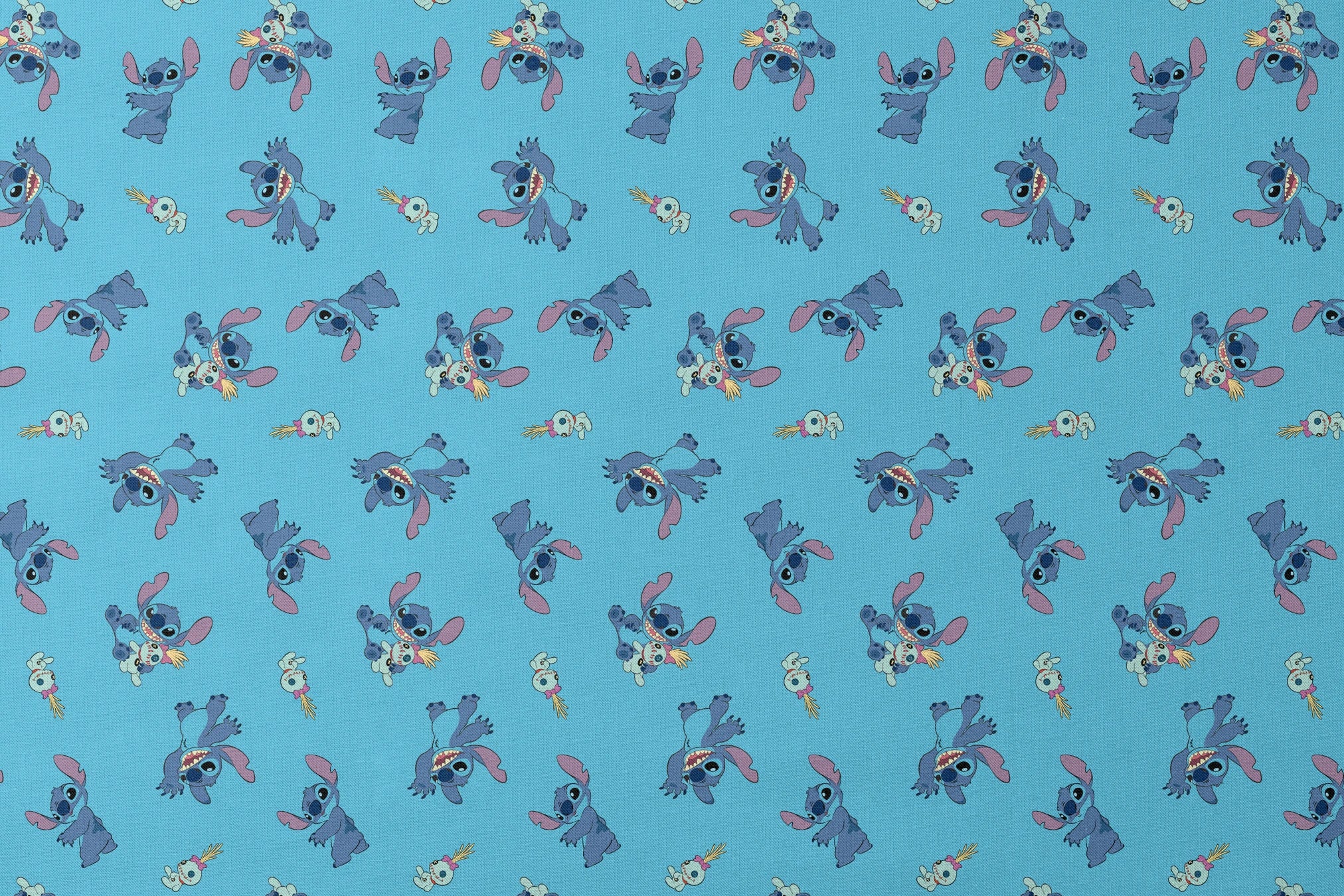 Disney’s Stitch and Scrump in various playful poses scattered across a light blue background with small tropical flowers. designs flat mockup