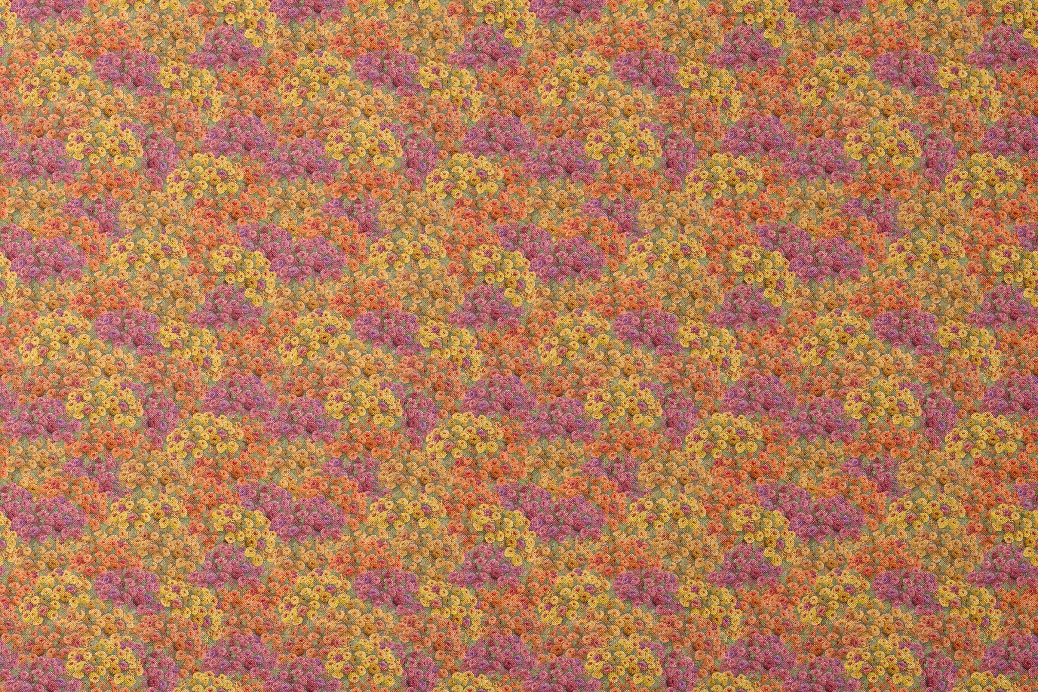 Dense floral fabric featuring orange, gold, pink, and plum zinnias in a packed all-over pattern by Nicole Tamarin. designs flat mockup