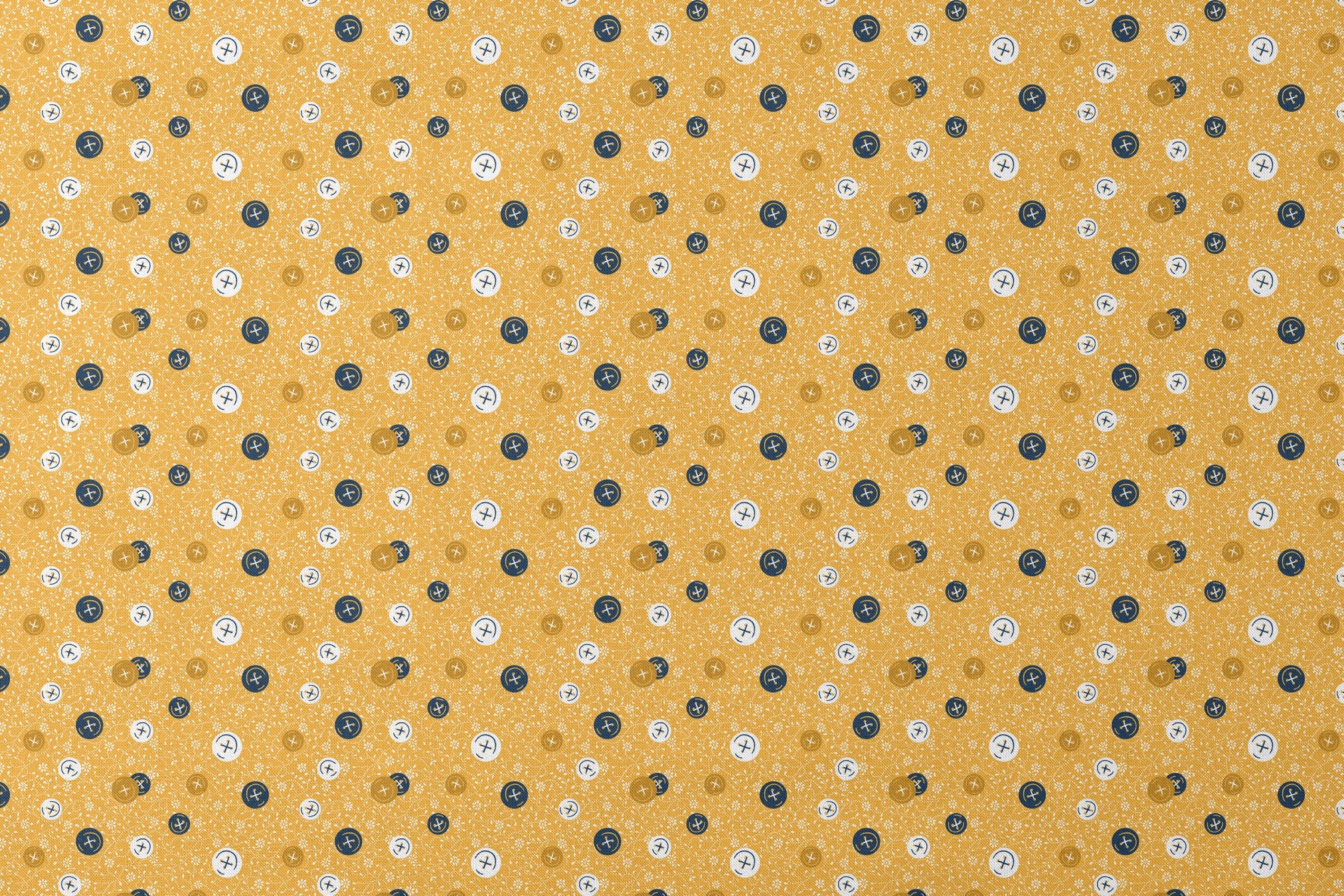 Circular buttons with cross symbols in gold, navy, and white scattered on a gold floral background designs flat mockup