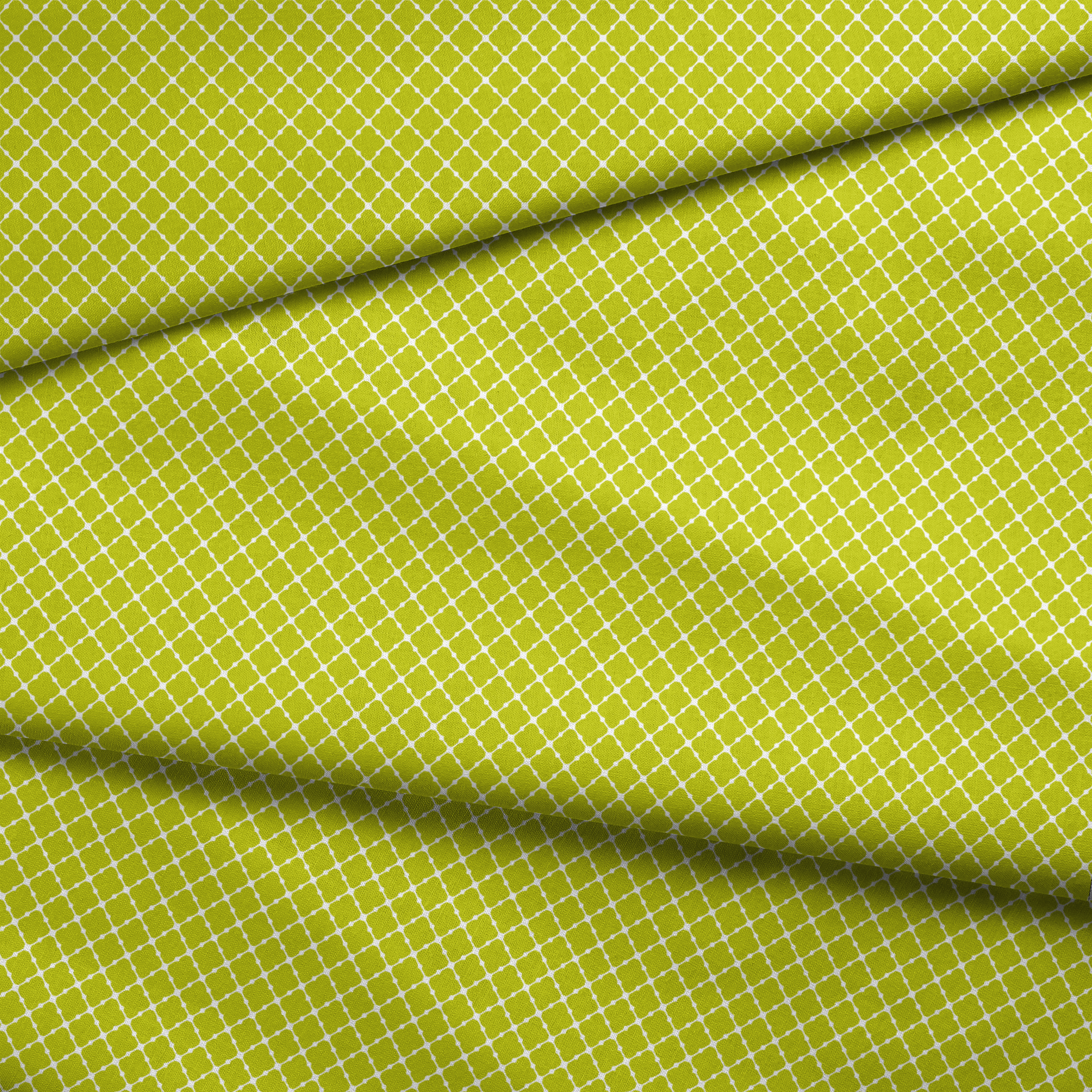 Chartreuse green quatrefoil pattern on white background, forming a geometric lattice design fabric fold mockup