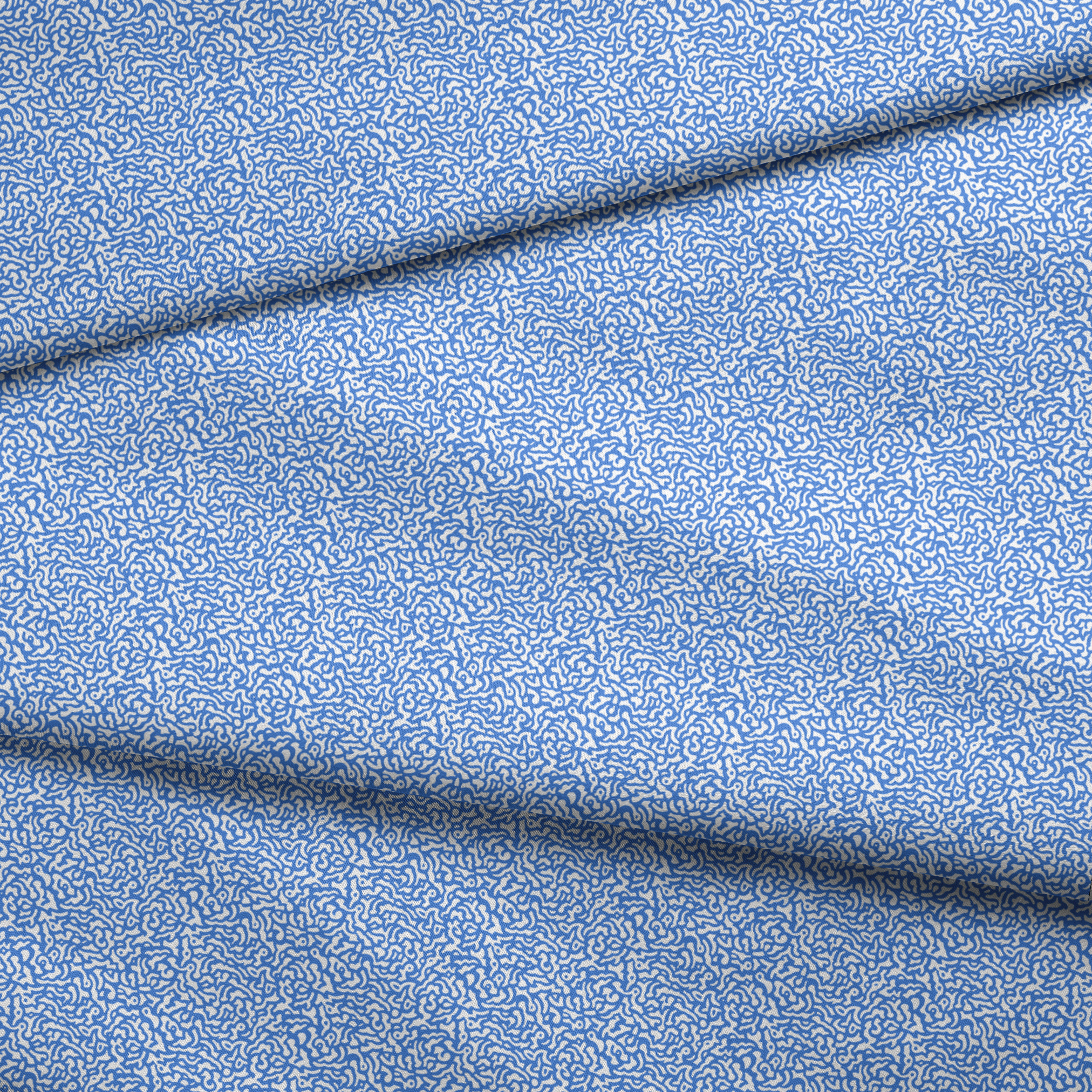 Blue and white abstract pattern with wavy, maze-like lines creating a flowing organic texture fabric fold mockup
