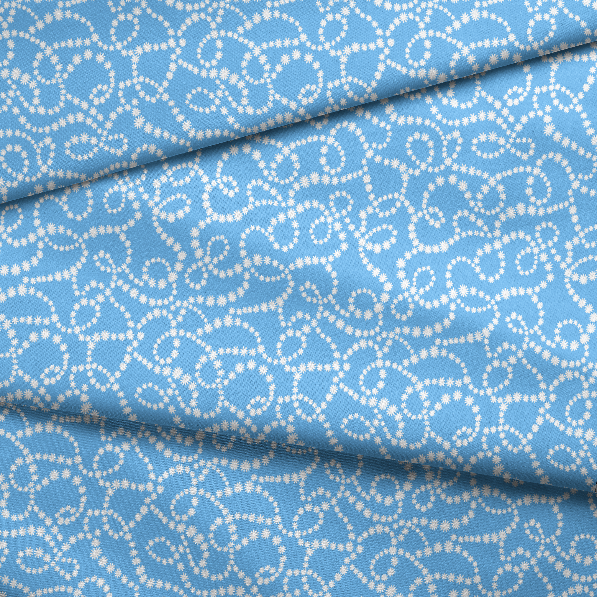 Sky blue background with swirling white dotted pattern resembling beaded strings or pearls arranged in curving lines fabric fold mockup
