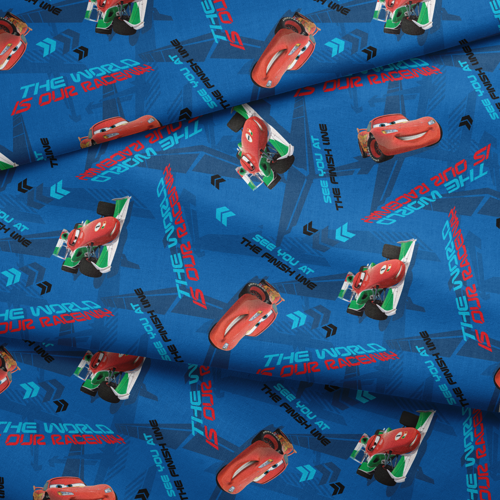 Blue fabric pattern with animated red race cars, "The World of Cars" text, and directional arrow designs fabric fold mockup