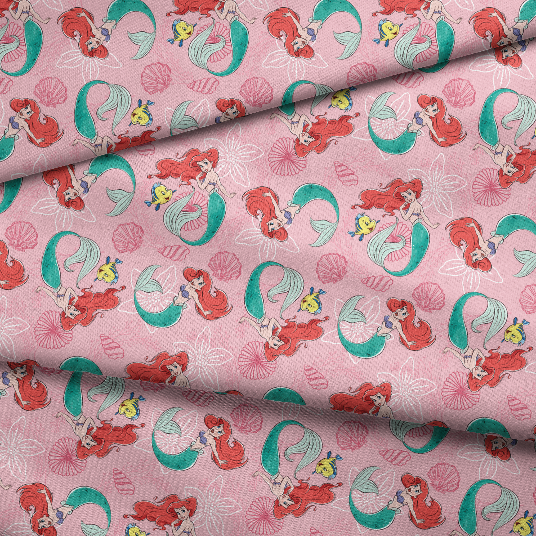 Illustrated pattern of mermaids with red hair and green tails swimming with yellow fish on pink seashell background fabric fold mockup