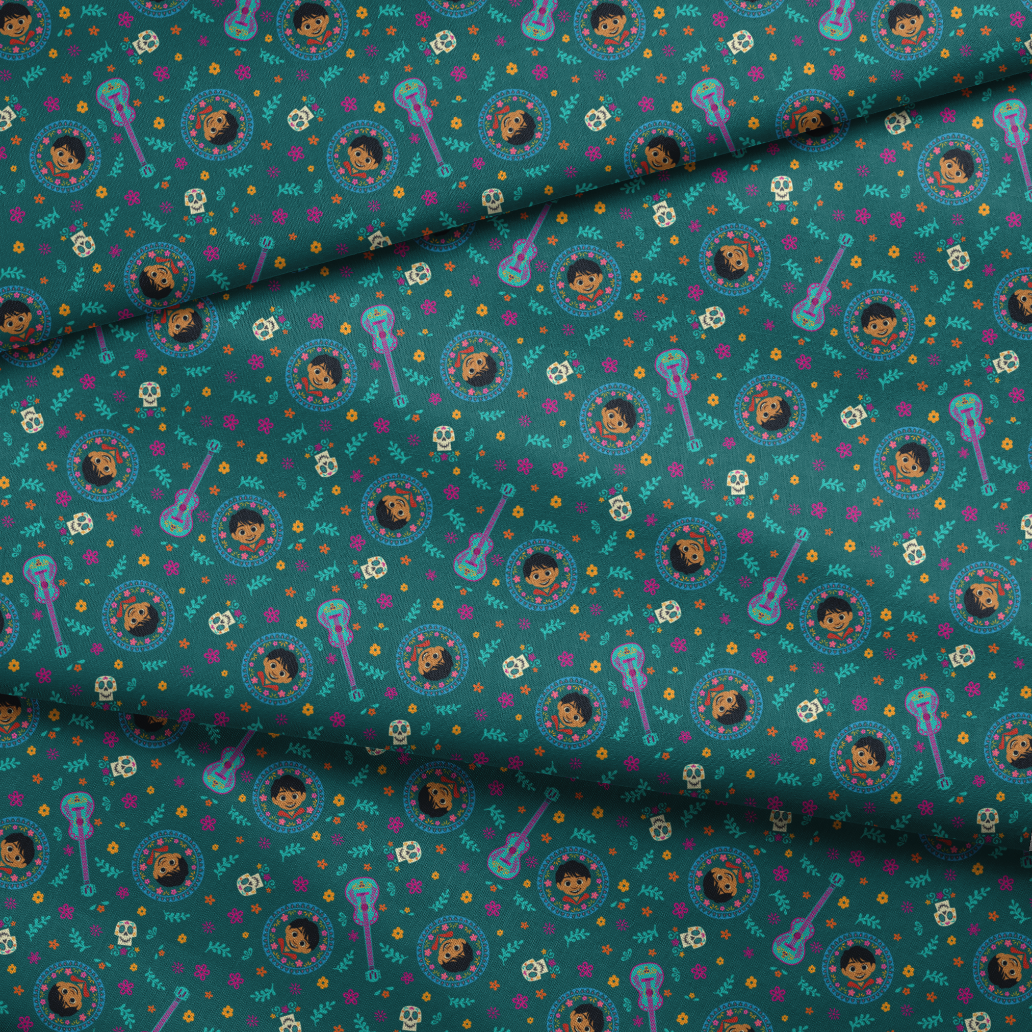 Colorful Coco-inspired pattern with guitars, sugar skulls, circular portraits, and floral elements on teal background. fabric fold mockup