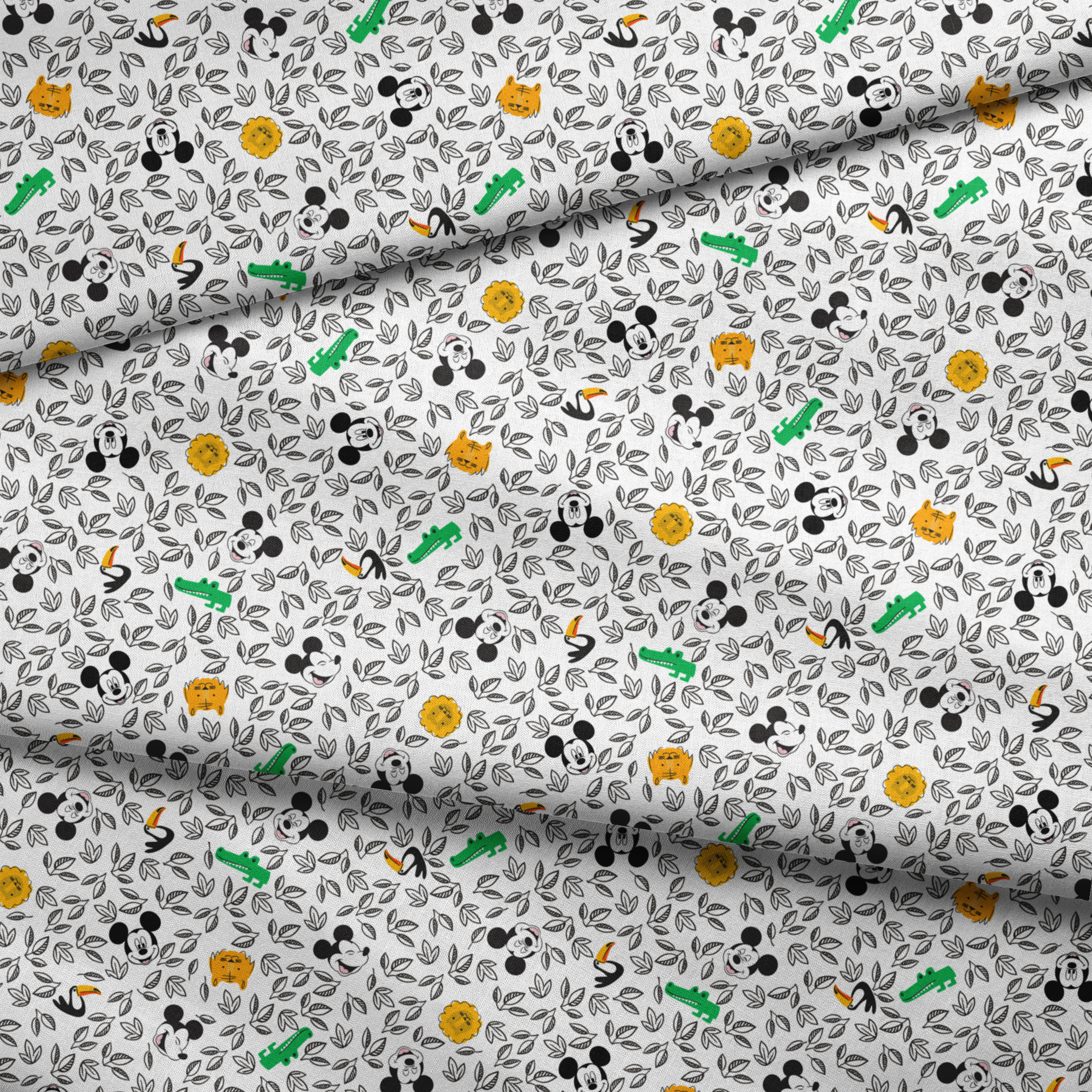 Pattern of cartoon Mickey Mouse silhouettes with yellow honeycomb, green bamboo, and black and white leaves fabric fold mockup