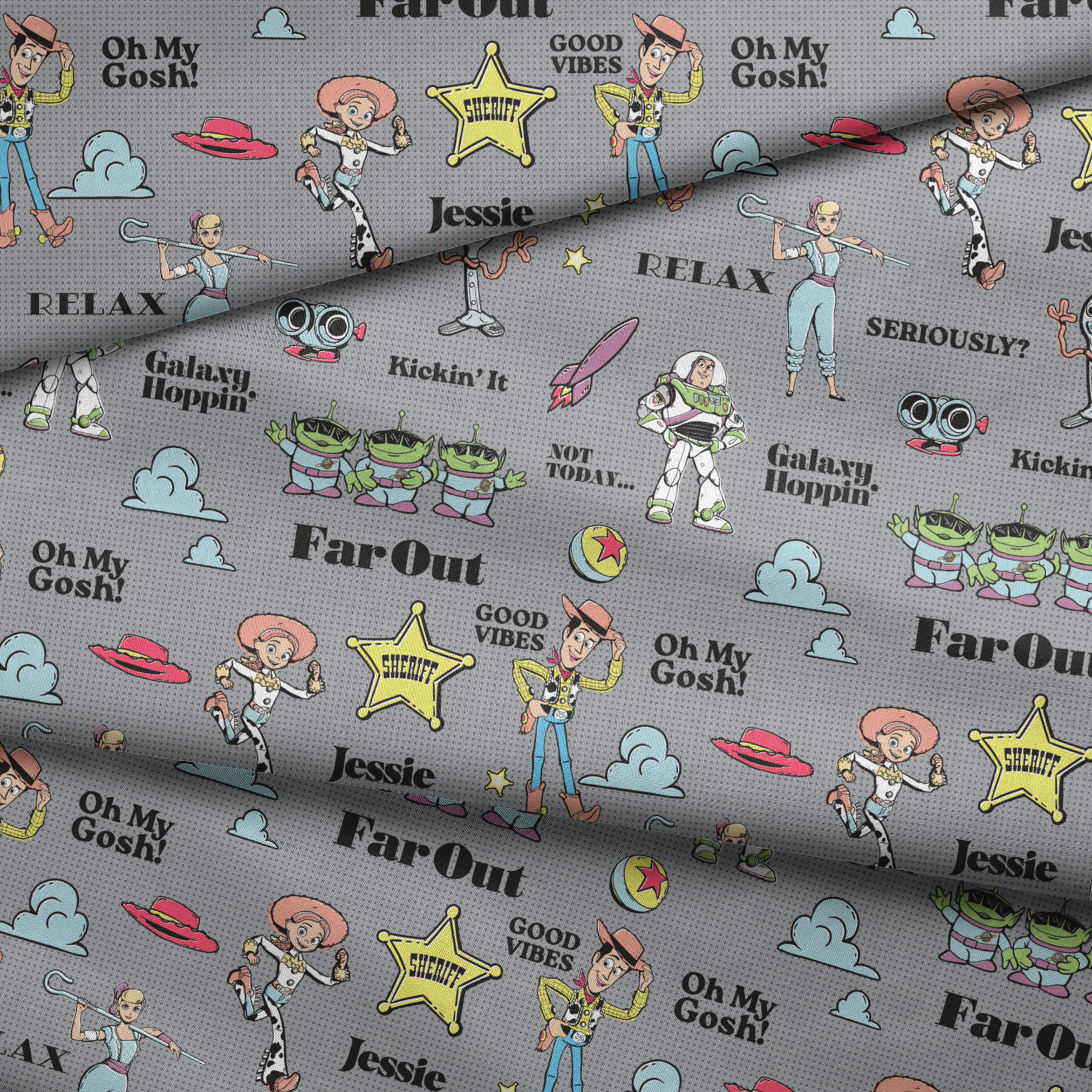 Toy Story character pattern with Buzz, Woody and aliens on gray background with phrases like "Good Vibes" and "Galaxy Hoppin' fabric fold mockup