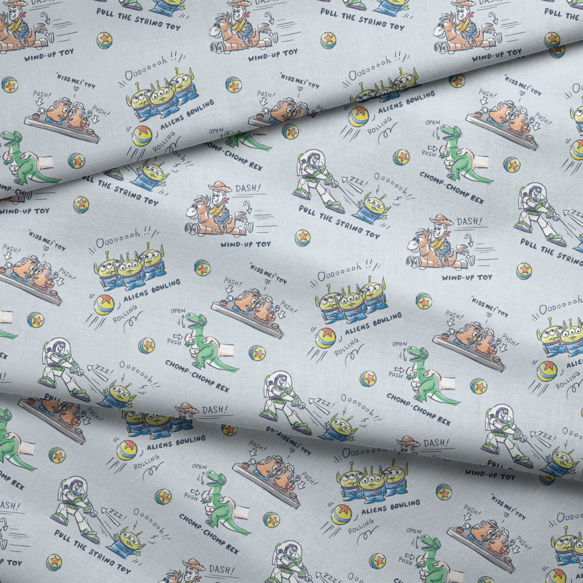 Illustrated Toy Story character designs showing wind-up, pull string, and action toys on light blue background fabric fold mockup