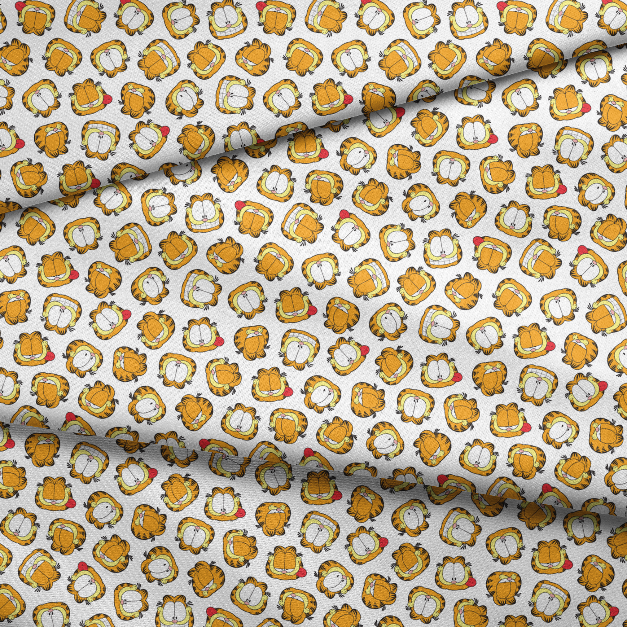 Pattern of cartoon cat faces with orange and yellow coloring against white background fabric fold mockup