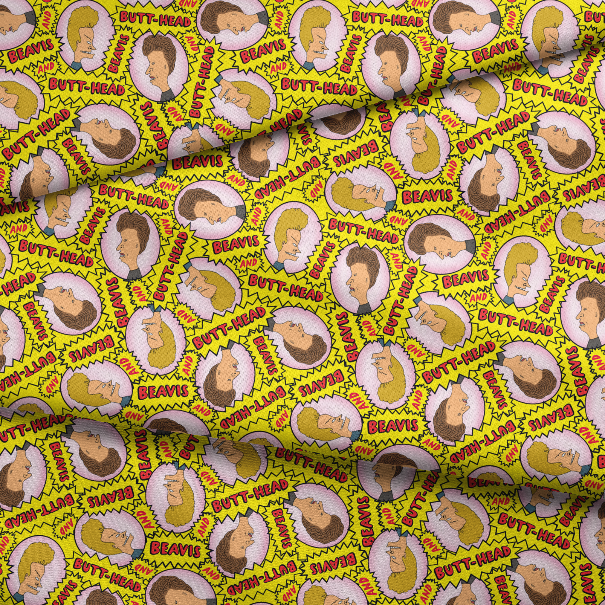 Yellow pattern with cartoon characters and text "BEAVIS" and "BUTT-HEAD" in comic-style speech bubbles repeated throughout fabric fold mockup