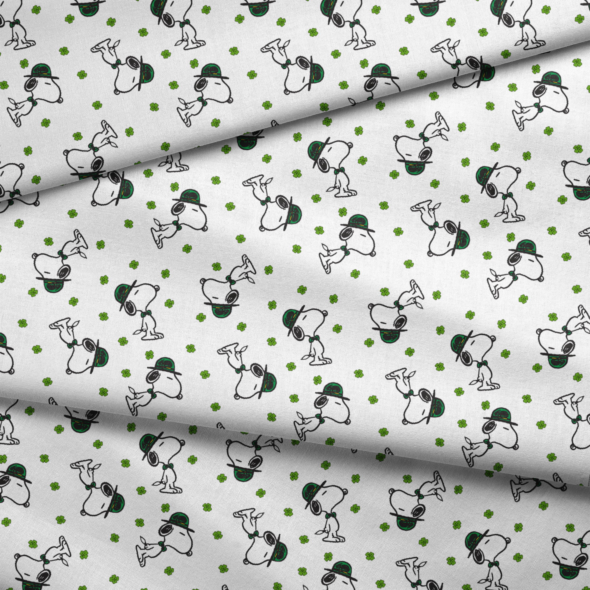 Cartoon Snoopy wearing green hat with shamrocks scattered across white background fabric fold mockup