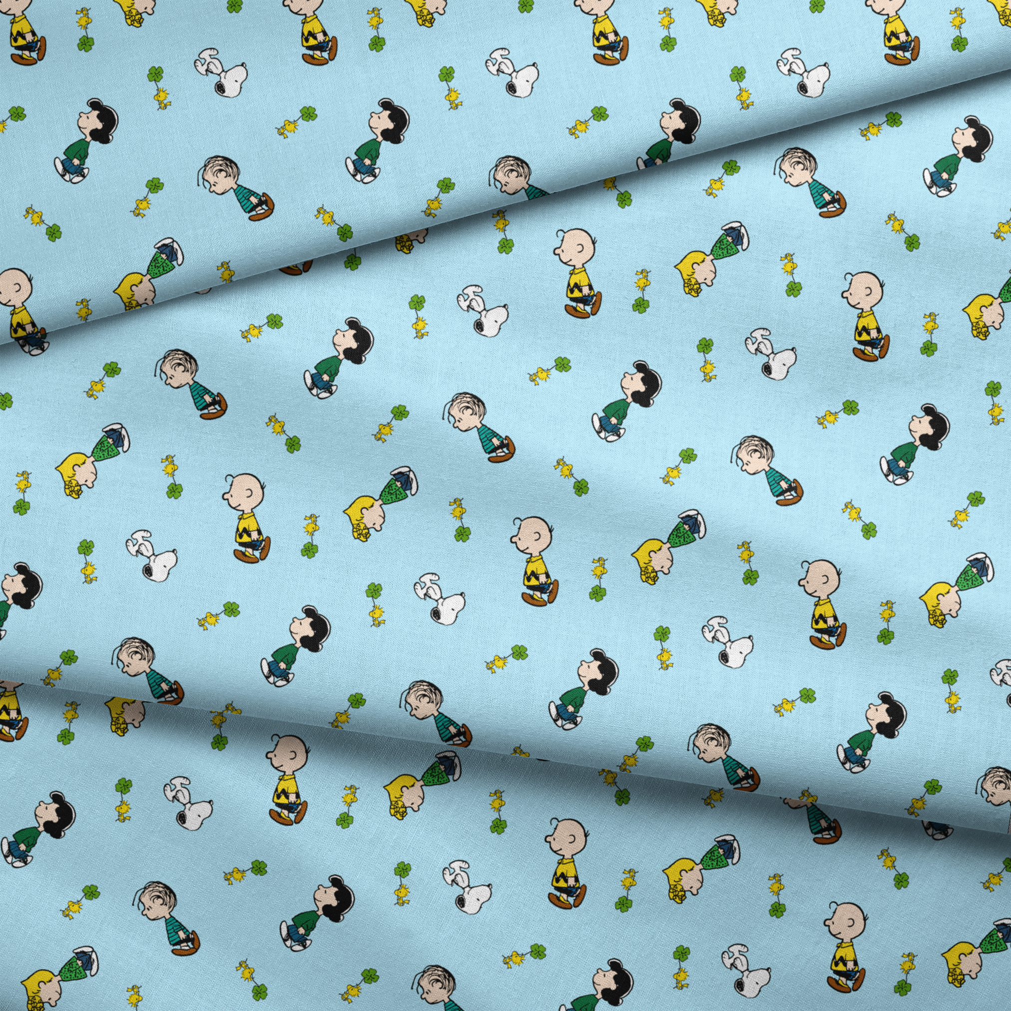 Peanuts cartoon characters on light blue background with clovers fabric fold mockup
