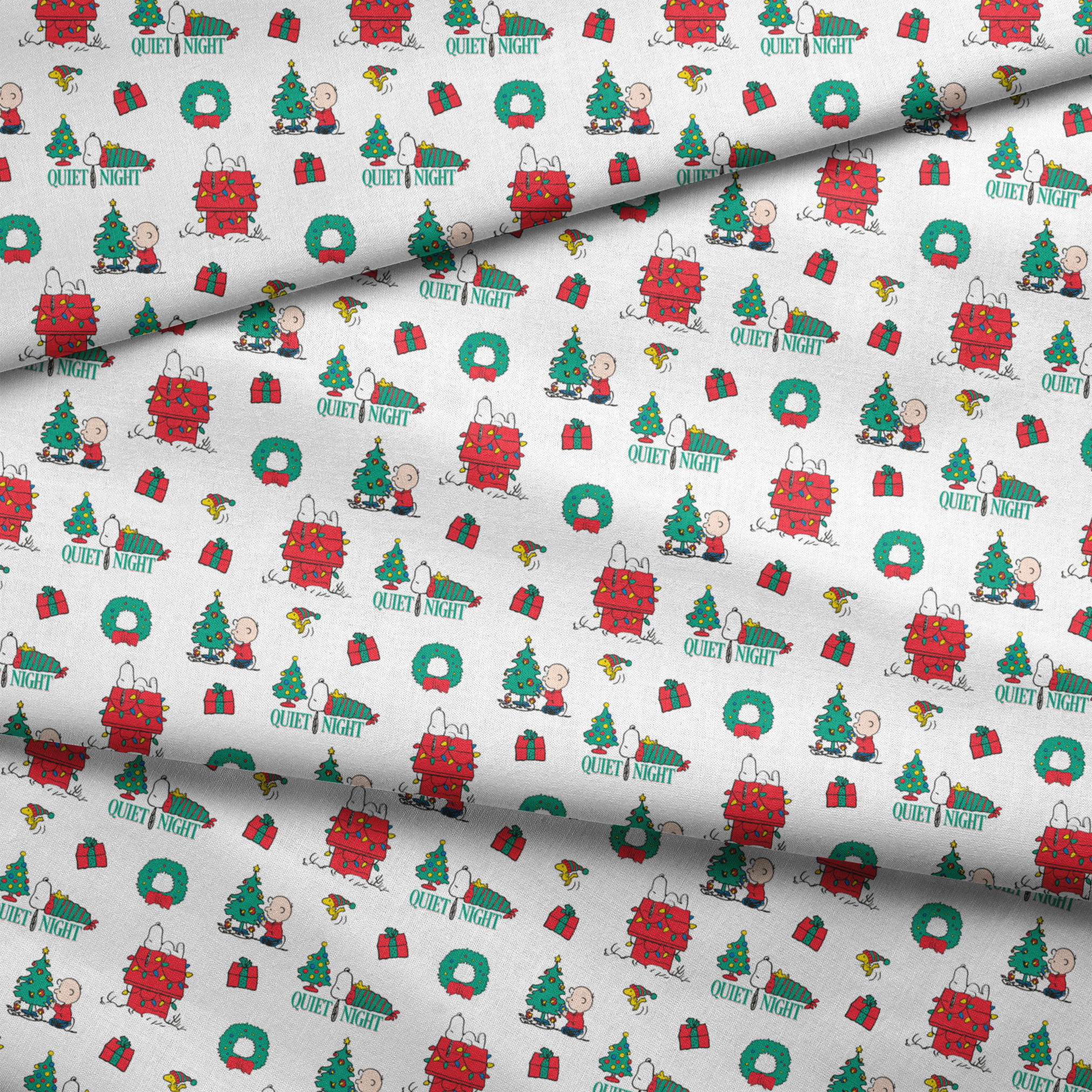 Peanuts Christmas pattern with Snoopy's decorated doghouse, trees, wreaths, and "Quiet Night" text fabric fold mockup