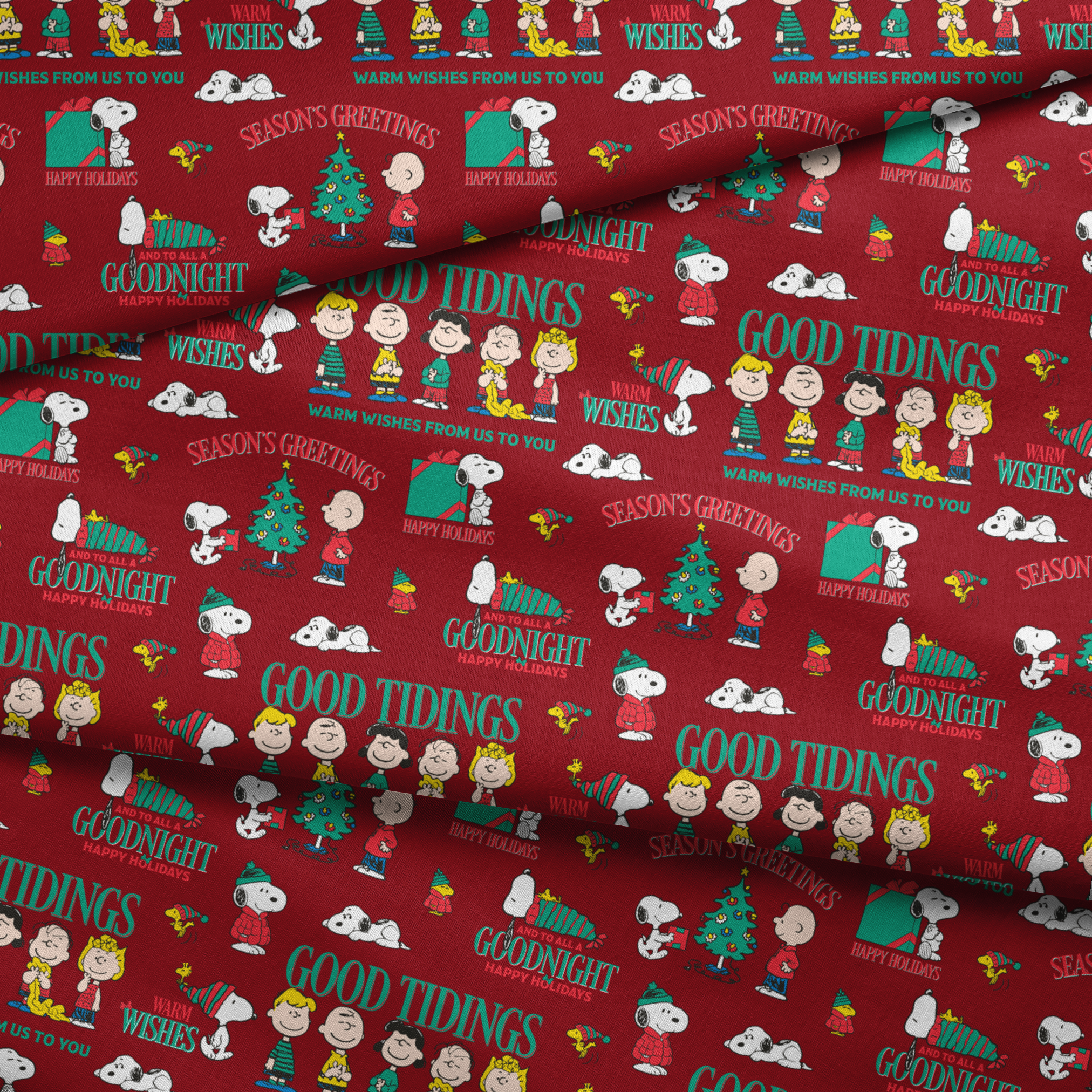 Colorful Peanuts Christmas pattern with Snoopy, Woodstock, and friends with holiday phrases on red background fabric fold mockup