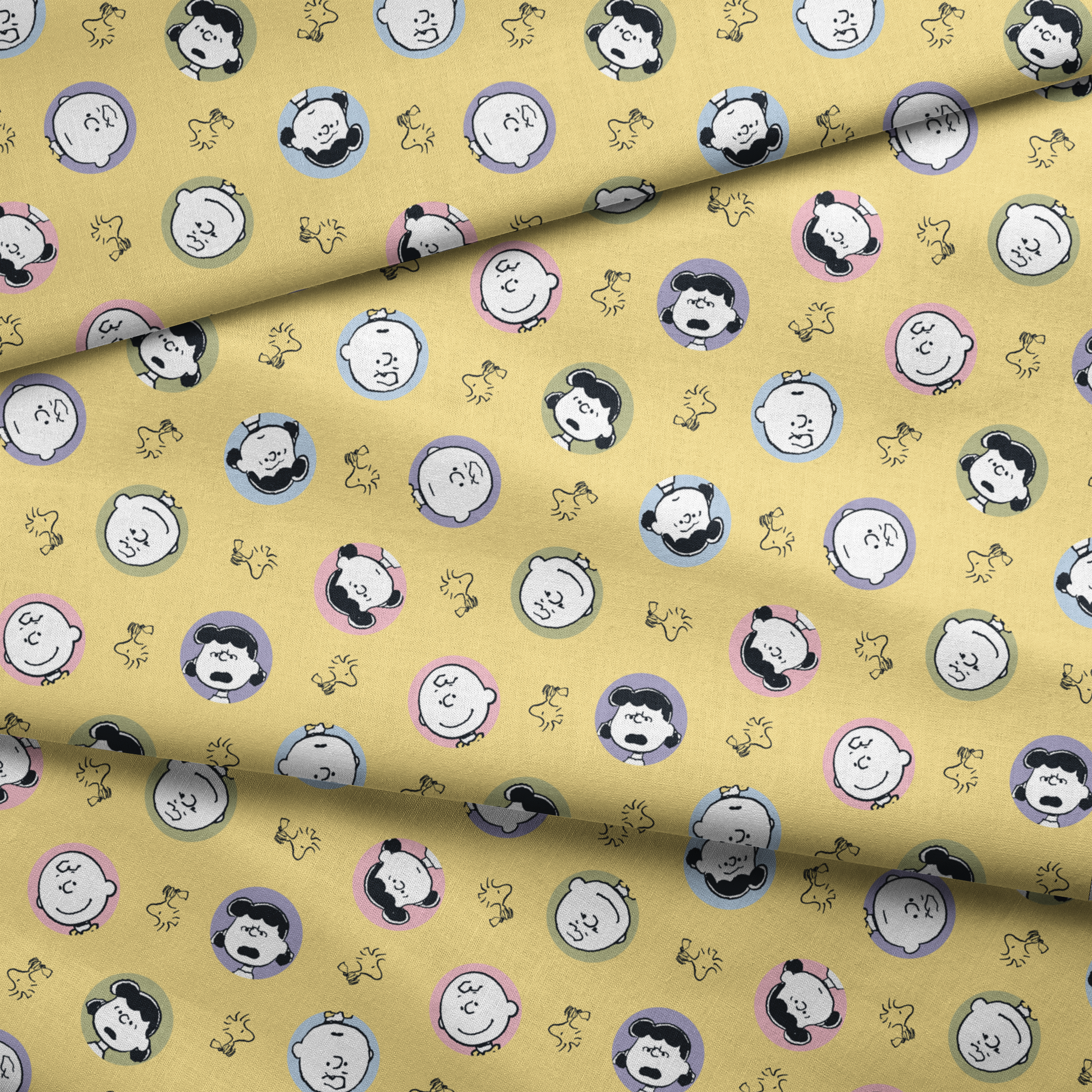 Peanuts characters pattern with Charlie Brown and friends in circular frames on yellow background with Woodstock silhouettes fabric fold mockup