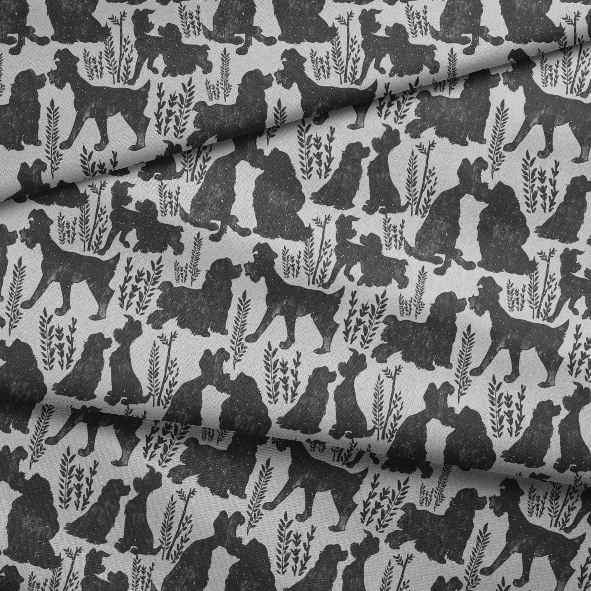 Repeating pattern of black dog silhouettes with decorative plant motifs on a light gray background fabric fold mockup