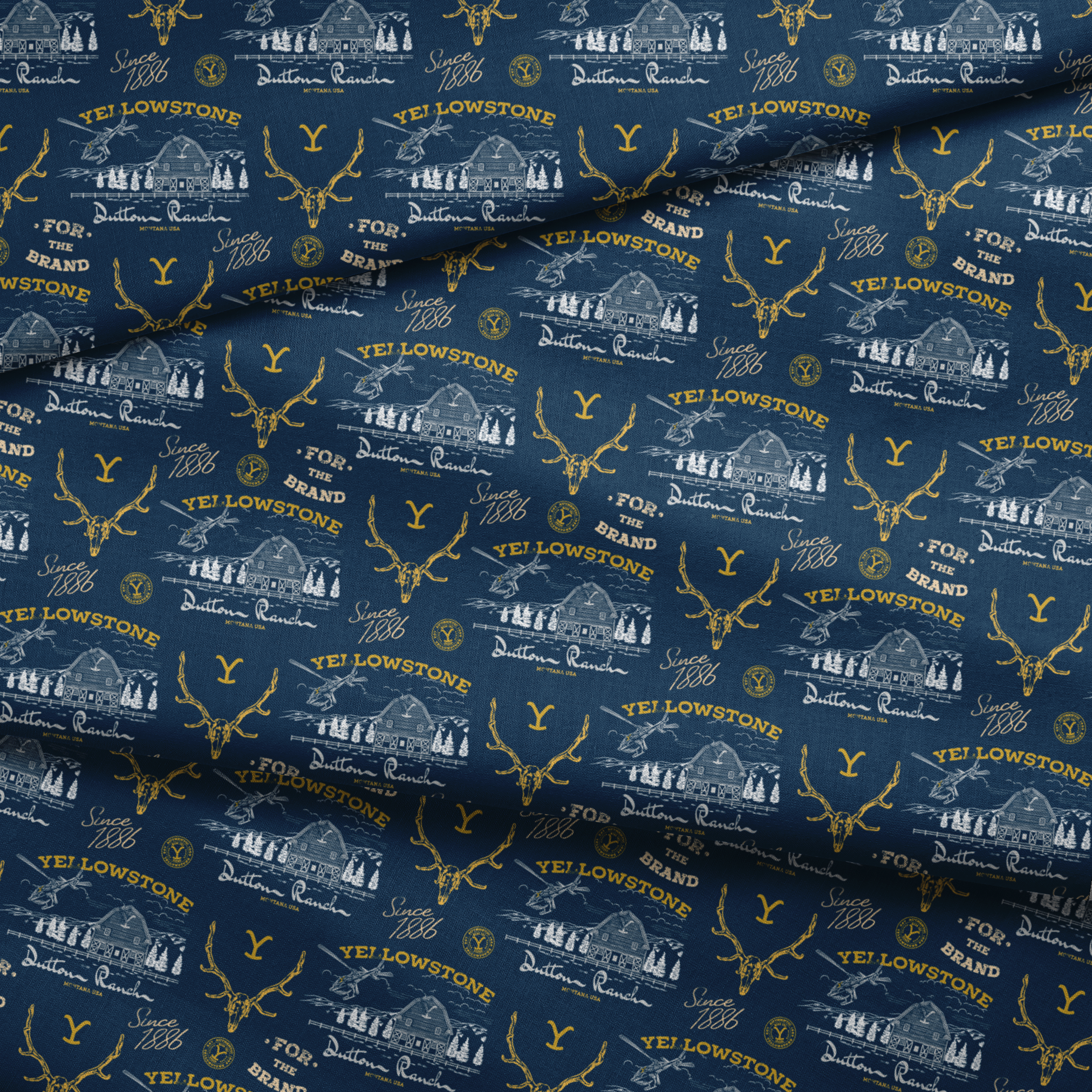 Yellowstone-themed pattern with Dutton Ranch logos, deer antlers, and "Y" branding on navy blue background fabric fold mockup