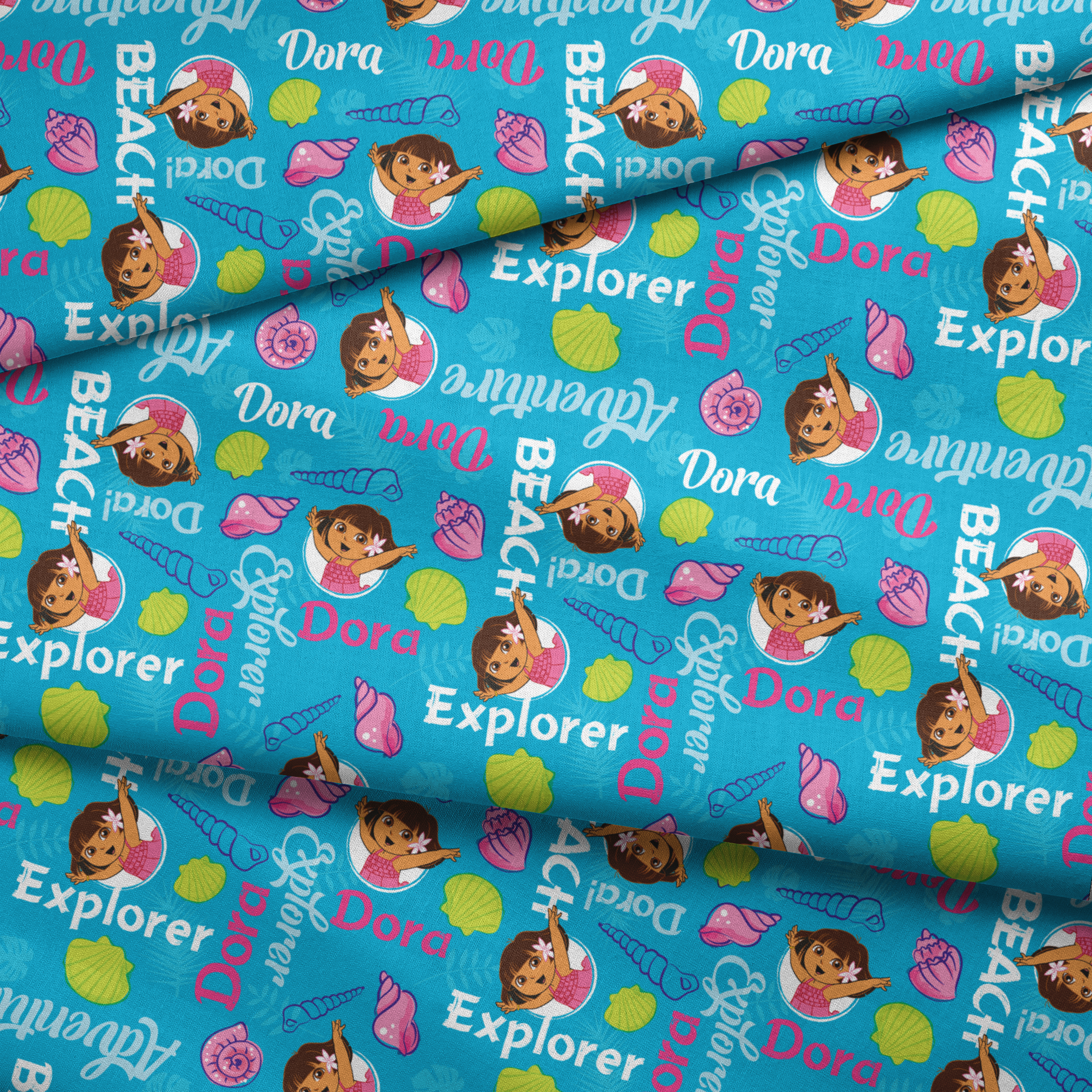 Bright blue pattern featuring Dora the Explorer cartoon character with seashells and "Beach Explorer" text fabric fold mockup