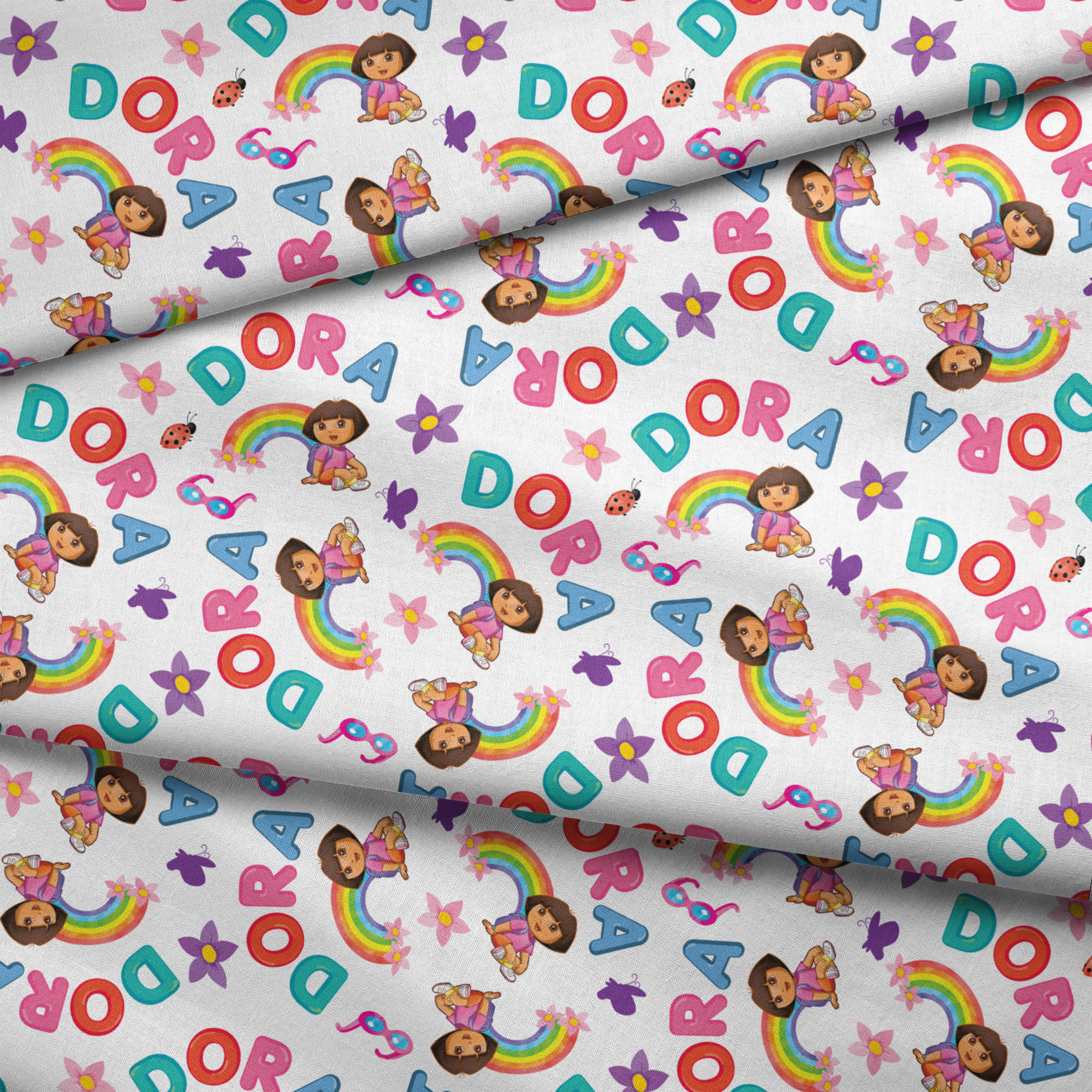 Colorful Dora pattern with rainbows, flowers, alongside scattered "DORA" letters on white background. fabric fold mockup