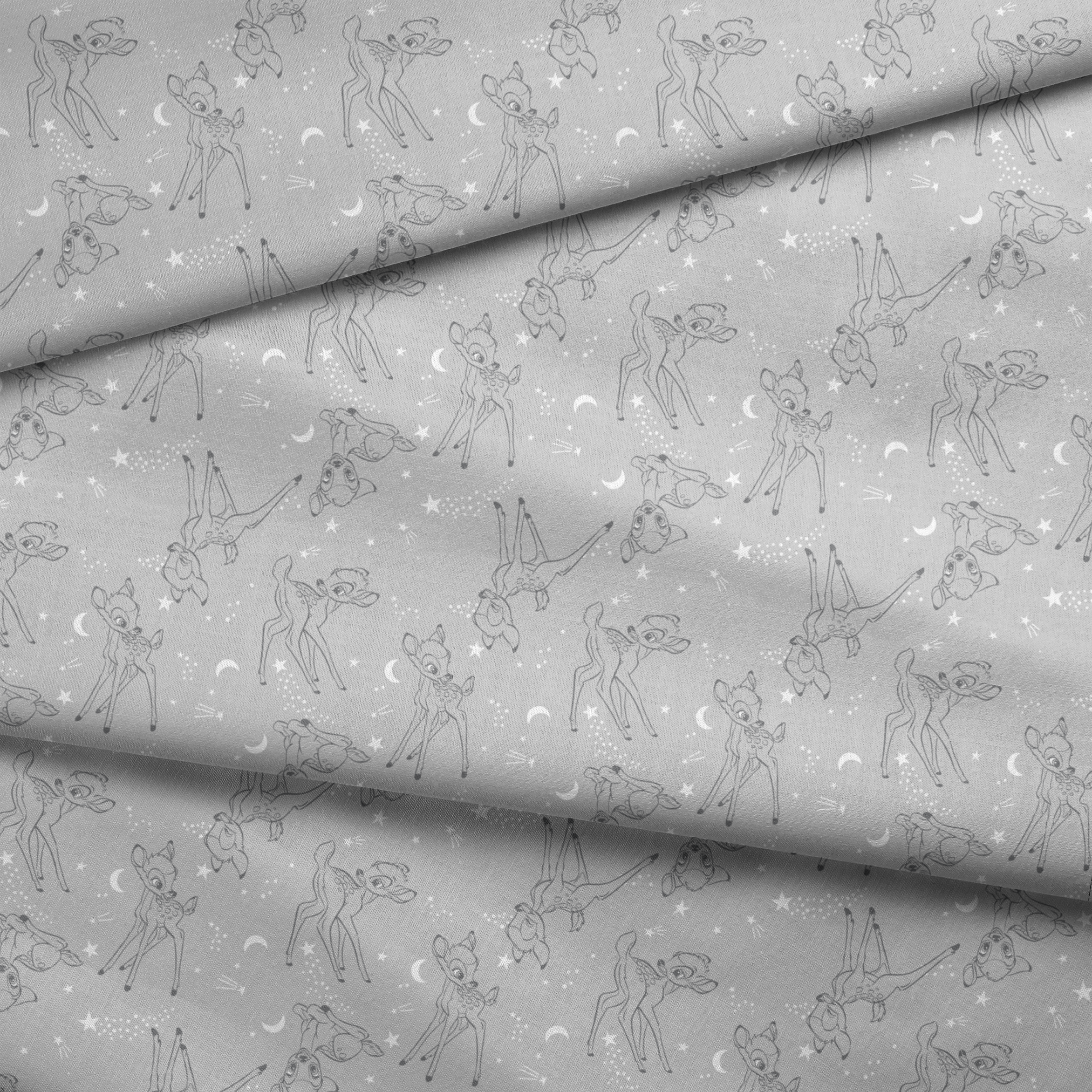 Line art illustrations of Disney’s Bambi surrounded by stars, moons, and stardust trails on a soft gray background in a scattered repeat. fabric fold mockup