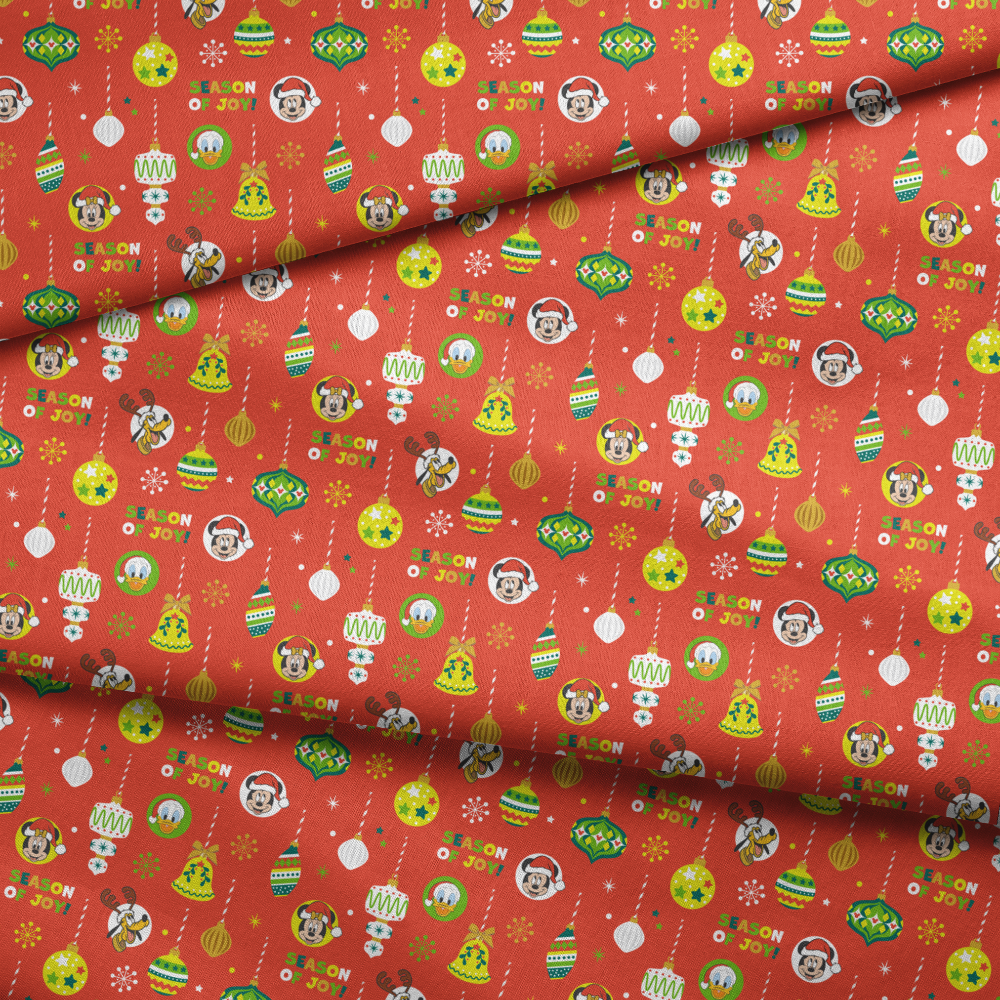 Christmas ornament pattern with colorful baubles, bells, snowflakes and Mickey Mouse characters on bright red background fabric fold mockup