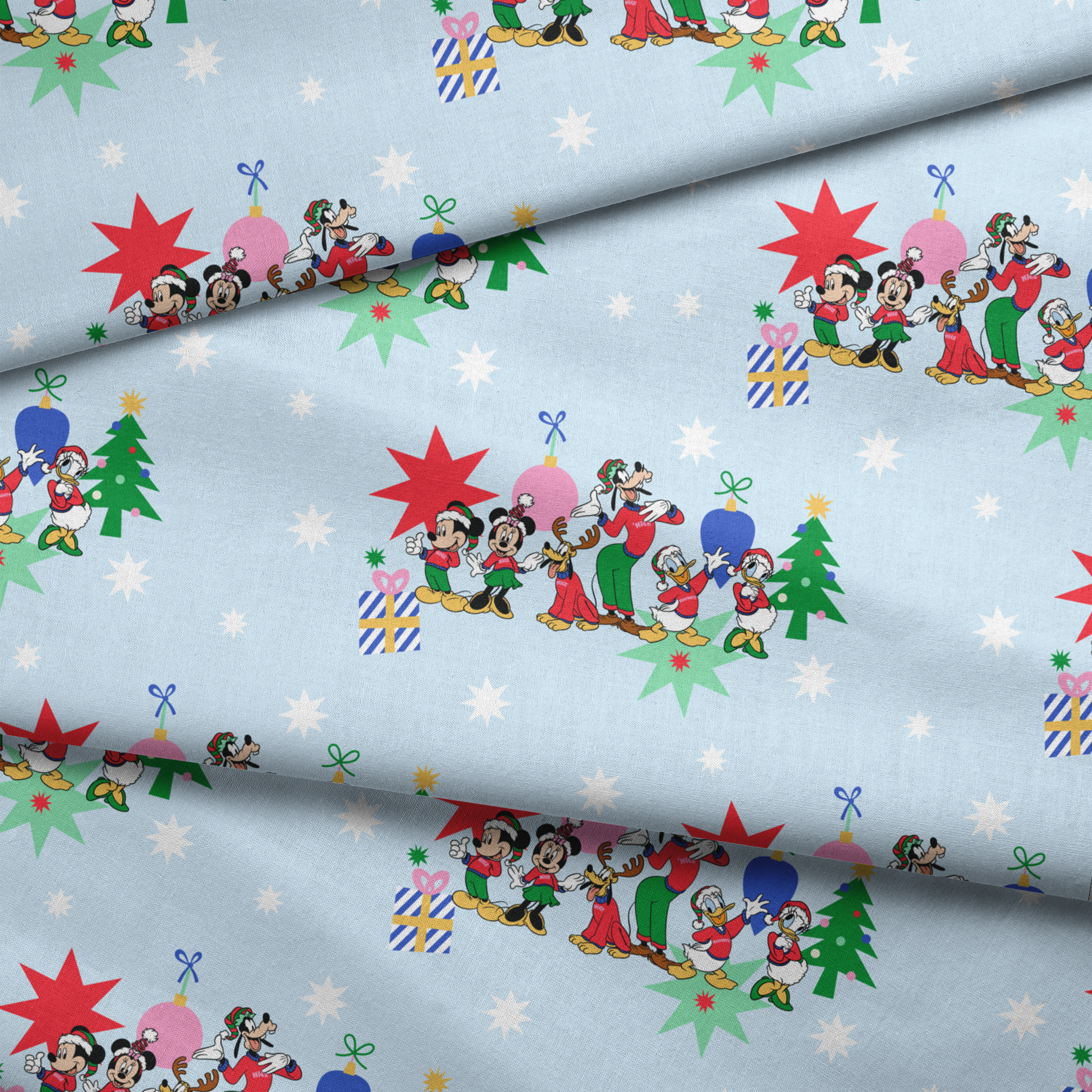 Cartoon Disney characters in festive poses with Christmas trees, ornaments, and stars on light blue snowy background fabric fold mockup
