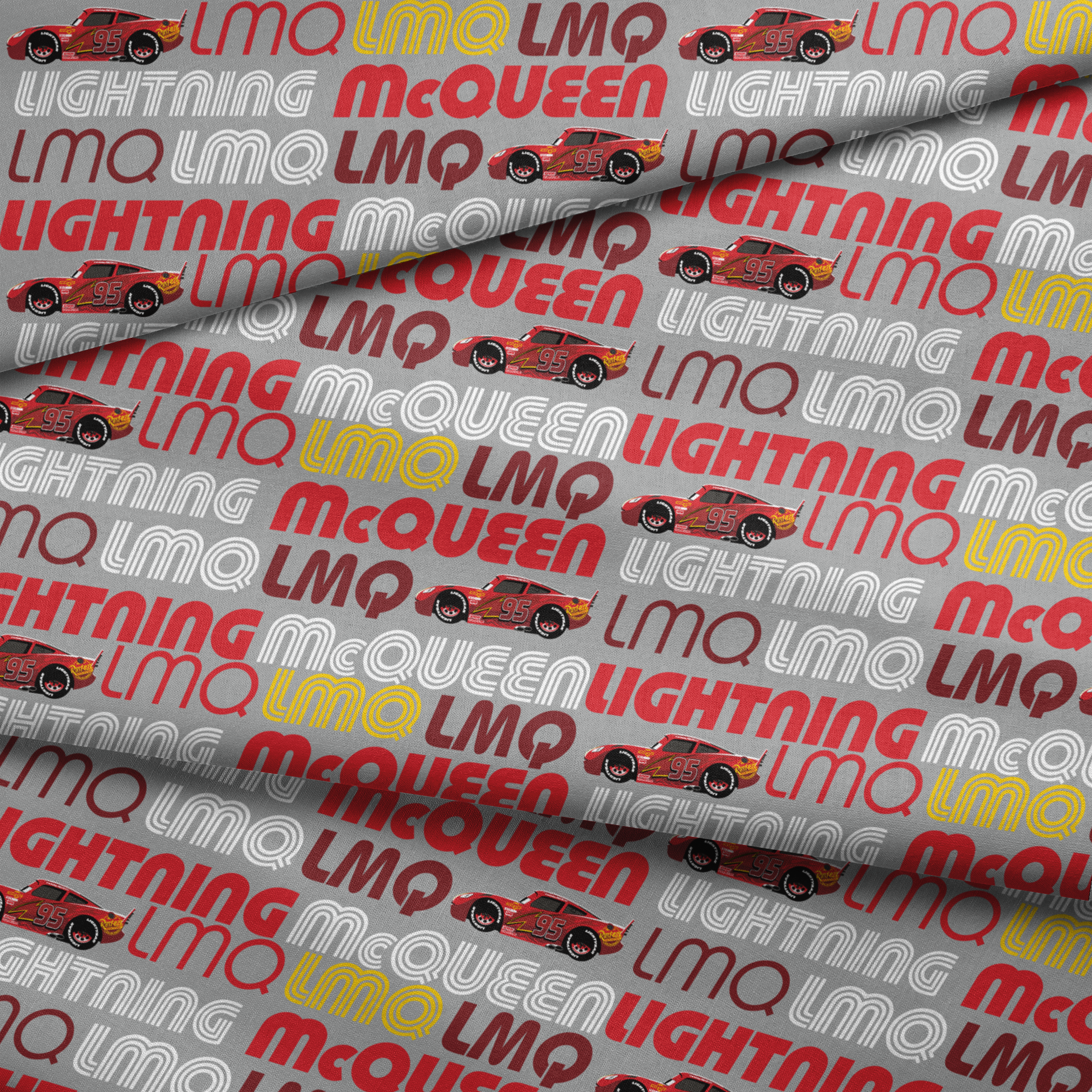 Lightning McQueen race car graphic with repeating LMQ text in red, yellow, and white on gray background fabric fold mockup