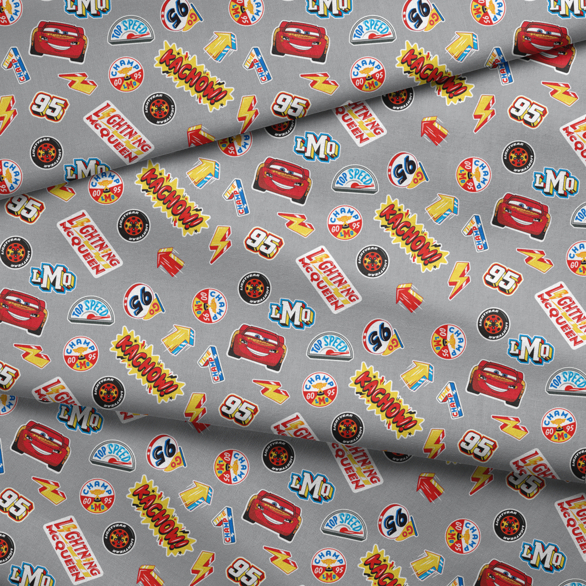 Colorful Disney Cars movie stickers featuring Lightning McQueen, racing logos, and numbers on gray background fabric fold mockup