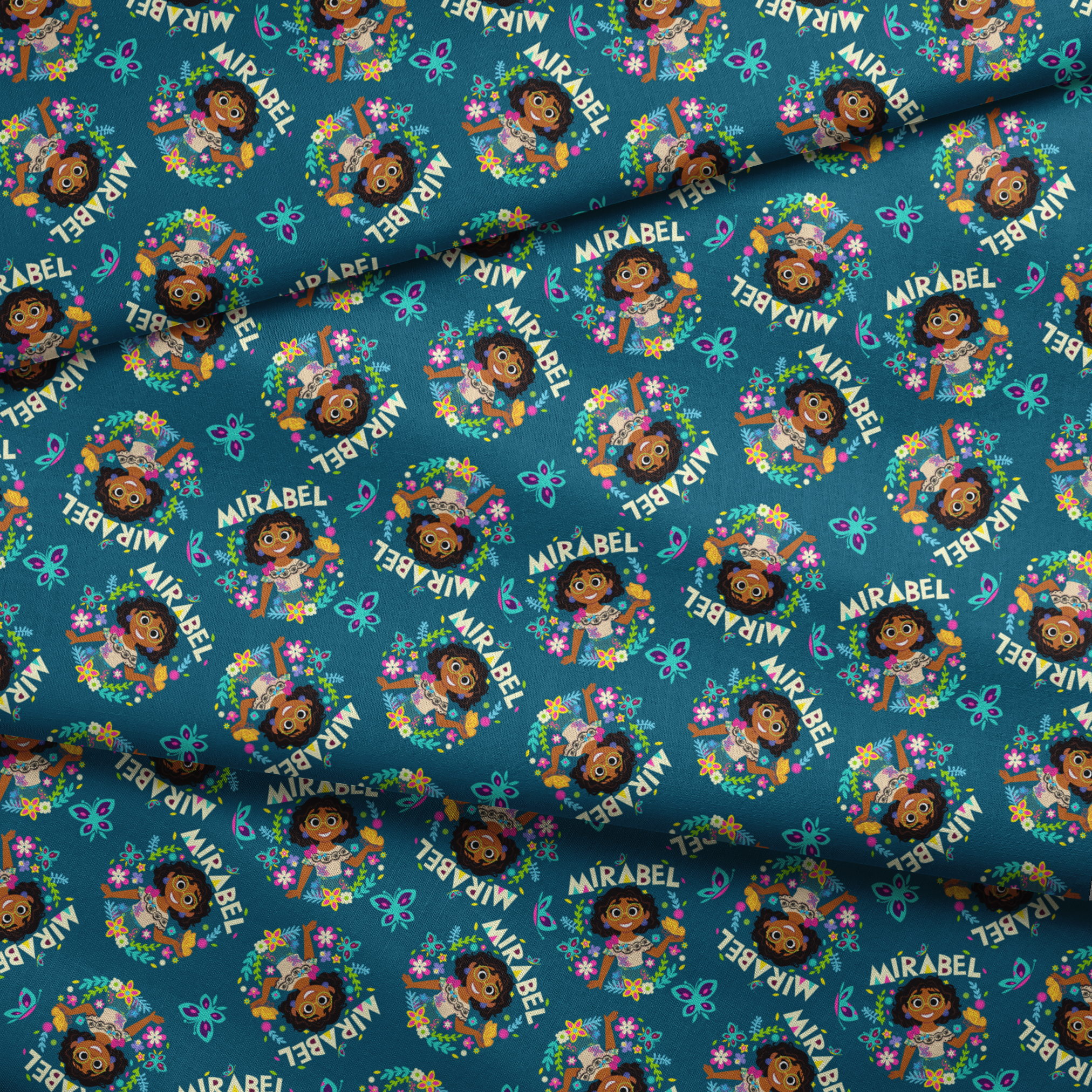Colorful cartoon pattern on teal background featuring characters, butterflies, flowers, and "Mirabel" text in repeating design fabric fold mockup