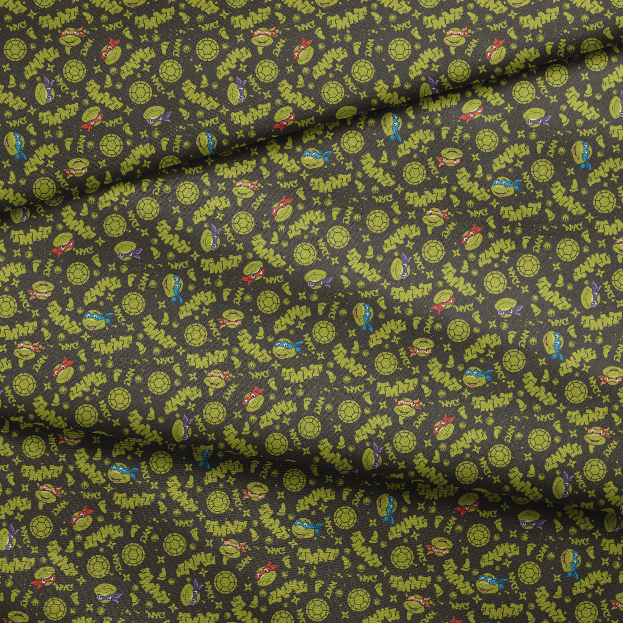 Pattern of Teenage Mutant Ninja Turtles with "TMNT" text on dark background fabric fold mockup