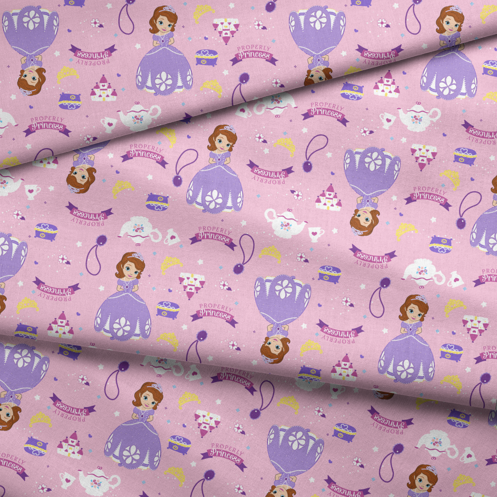 Princess-themed pattern with purple dresses, tiaras, teapots, and banners on pink background fabric fold mockup