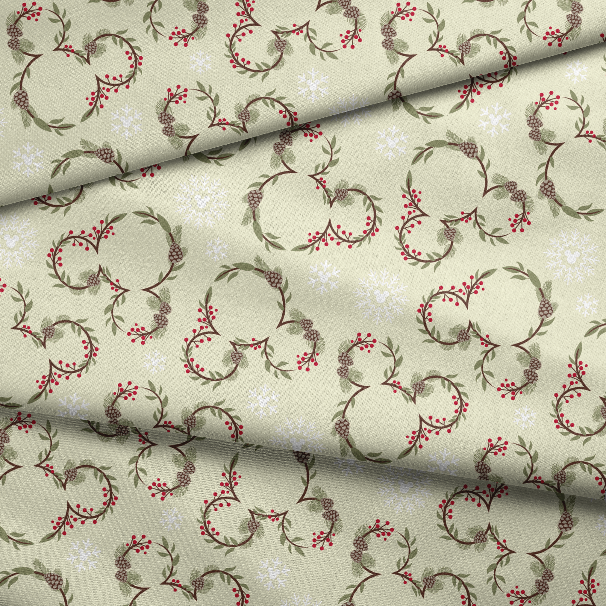 Holiday pattern with pine wreaths, red berries, and white snowflakes on light green background fabric fold mockup